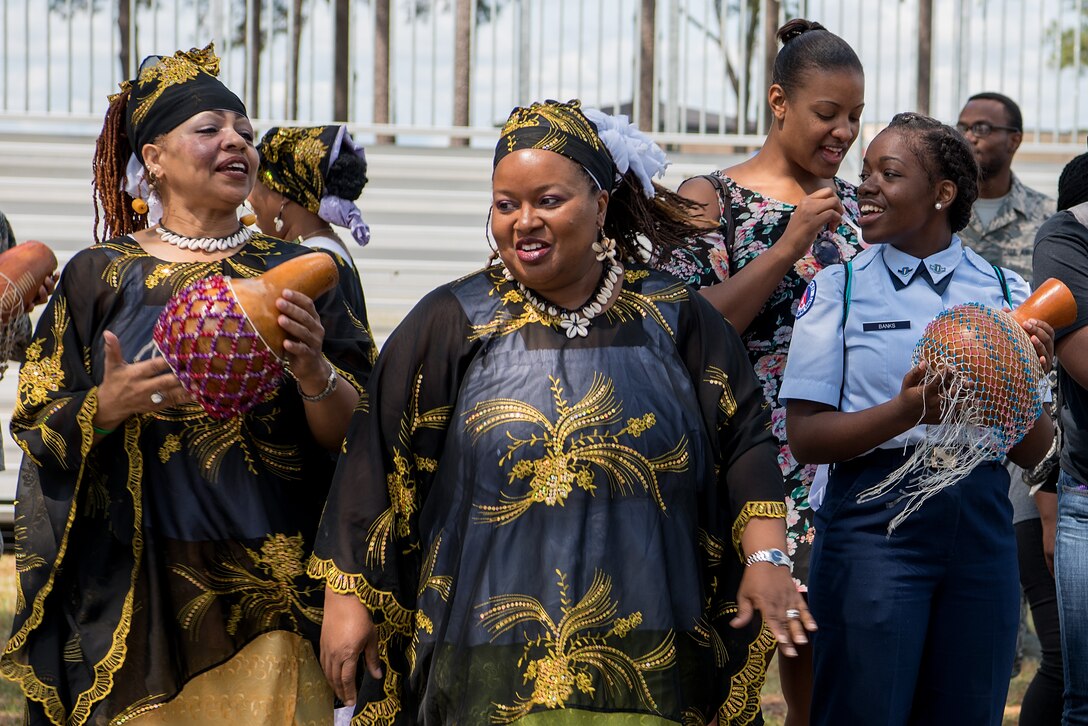A group performs a traditional African dance with the crowd during a Diversity Day celebration, April 27, 2018, at Seymour Johnson Air Force Base, North Carolina.