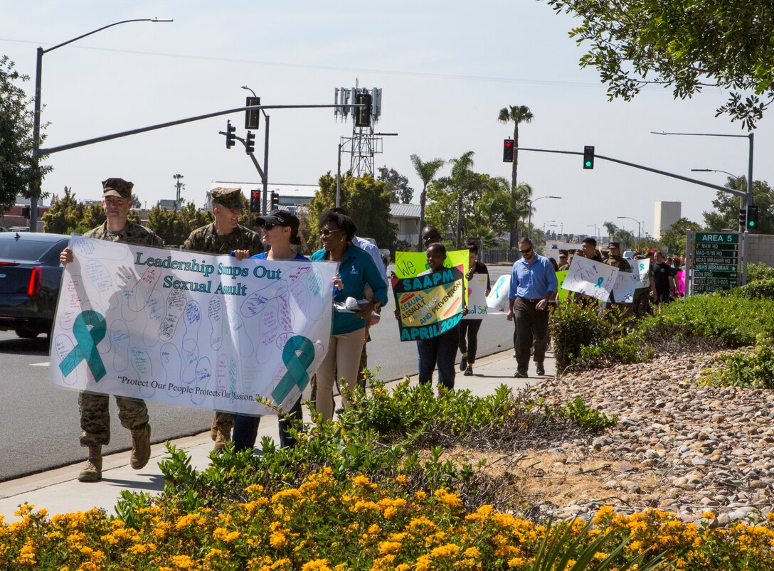 Marines, Sailors and civilians participate in “Forward March,” an annual Sexual Assault Prevention and Response (SAPR) walk on Marine Corps Air Station Miramar, Calif., April 26. SAPR staff and unit leaders at MCAS Miramar recognized Sexual Assault Awareness Month by hosting a series of events and organizing displays to raise awareness about sexual assault and highlight available resources. (U.S. Marine Corps photo by Cpl. Becky Calhoun/Released)