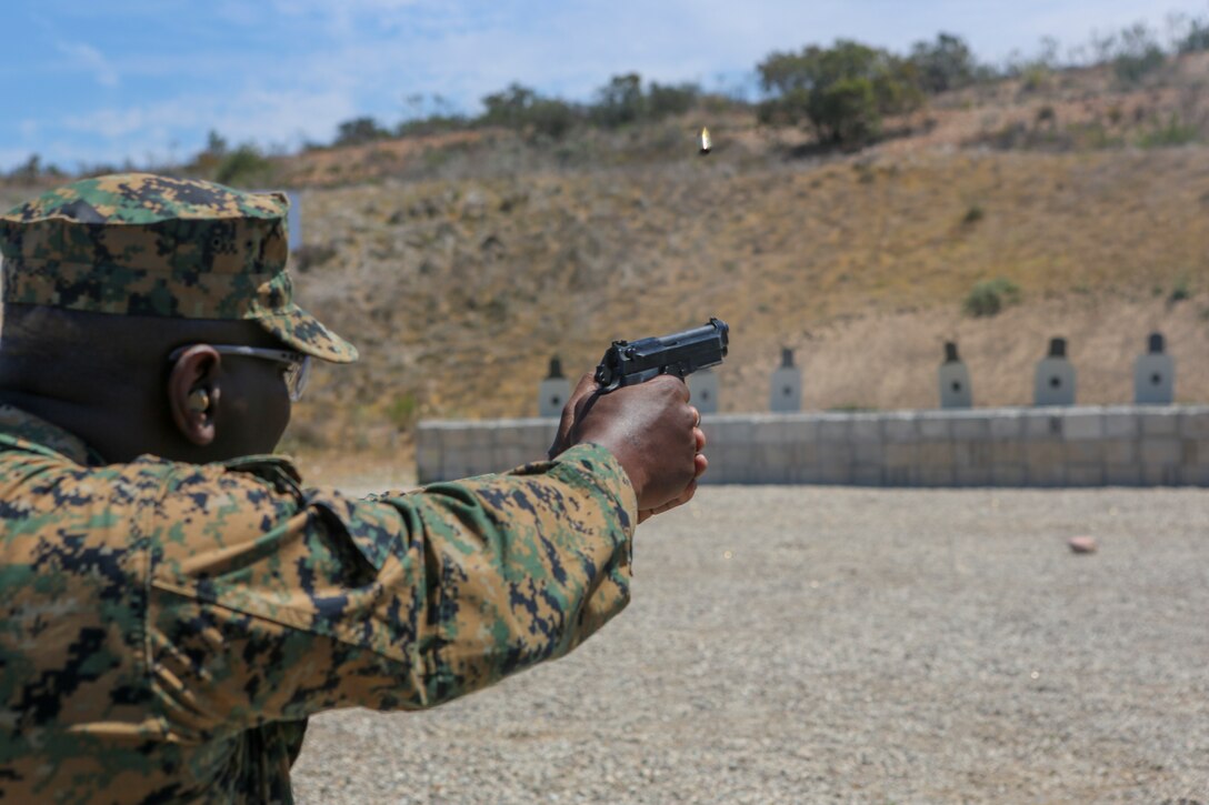 Sgt Maj. Alfred R. Broadus, sergeant major of Headquarters and Headquarters Squadron (H&HS), participates in a pistol marksmanship competition as part of the “Warrior Challenge” at Marine Corps Air Station Miramar, Calif., April 26. The “Warrior Challenge” is a monthly competition between all of the sections in H&HS to promote camaraderie and a healthy competitive spirit. (U.S. Marine Corps photo by Cpl. Daniel Auvert/Released).