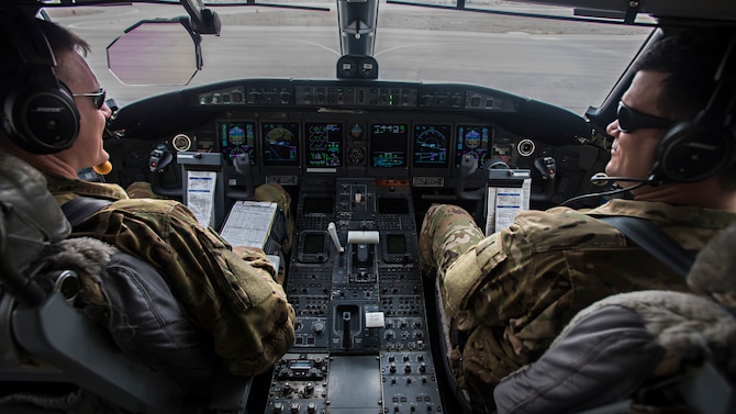 Lt. Col. Chris and Maj. Matt, 430th Expeditionary Electronic Combat Squadron, prepare to fly the Battlefield Airborne Communications Node’s 10,000th mission in an aircraft, Feb. 24, 2017. The BACN weapons system was developed to fulfill an urgent need in Afghanistan where communication is difficult. (U.S. Air Force photo by Staff Sgt. Katherine Spessa)