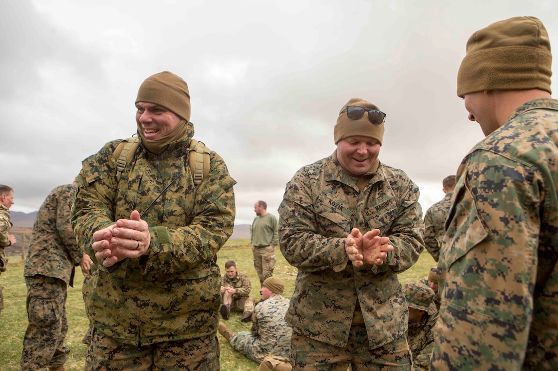 Marines attempt to escape from zip-tie handcuffs during survival training in Durness, Scotland.