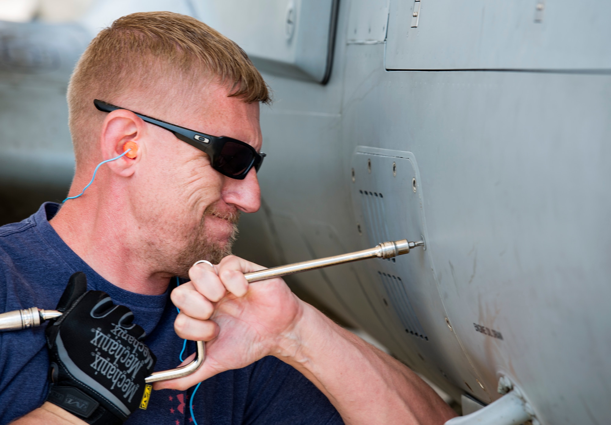 Joe Johnson, Sierra Nevada Corporation (SNC) avionics technician, unscrews an access panel on an A-29 Super Tucano, April 26, 2018, at Moody Air Force Base, Ga. The 81st Fighter Squadron received the aircraft to help continue the Afghan light air support training mission, which ultimately provides Afghan pilots with the capabilities of finding, tracking, and attacking targets either on their own or in support of ground forces. The aircraft will be used by the Afghan Air Force for close-air attack, air interdiction, escort and armed reconnaissance. SNC is an American privately held electronic systems provider and systems integrator, and are the primary technicians and pilot instructors of the A-29s. (U.S. Air Force photo by Airman 1st Class Erick Requadt)
