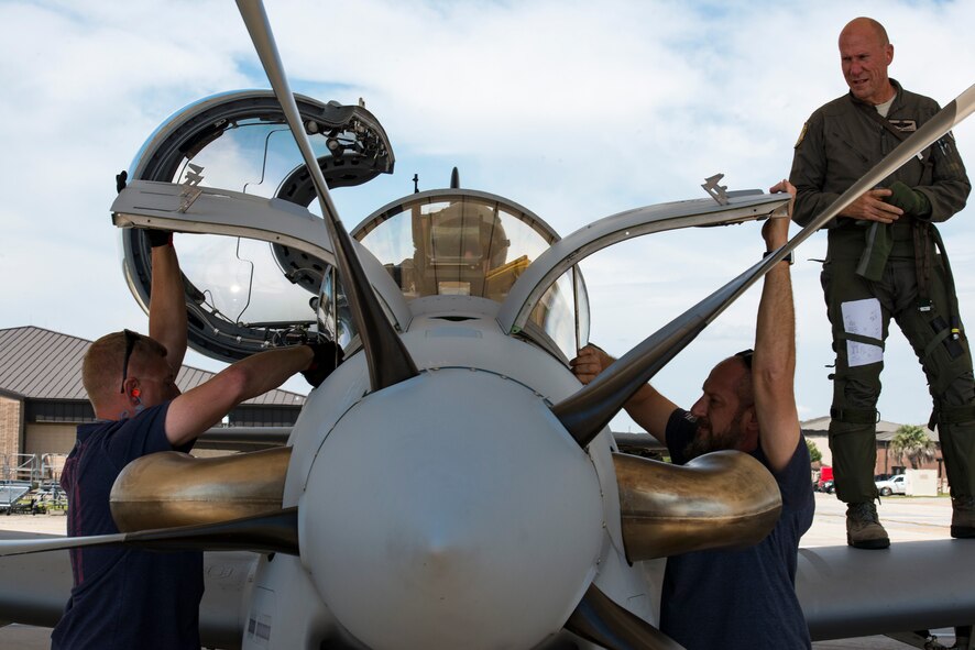 Contractors from the Sierra Nevada Corporation (SNC) perform a post-flight inspection on an A-29 Super Tucano, April 26, 2018, at Moody Air Force Base, Ga. The 81st Fighter Squadron received the aircraft to help continue the Afghan light air support training mission, which ultimately provides Afghan pilots with the capabilities of finding, tracking, and attacking targets either on their own or in support of ground forces. The aircraft will be used by the Afghan Air Force for close-air attack, air interdiction, escort and armed reconnaissance. SNC is an American privately held electronic systems provider and systems integrator, and are the primary technicians and pilot instructors of the A-29s. (U.S. Air Force photo by Airman 1st Class Erick Requadt)