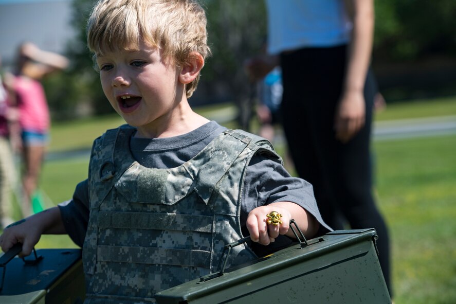 A participant races while carrying empty ammunition cans during the 2018 Kid’s Deployment Line, April 28, 2018, at Moody Air Force Base, Ga. The event allowed children the opportunity to experience what their parents go through while preparing to deploy. Children participated in obstacle courses, watched demonstrations and toured various aircraft and vehicles used by Airmen at Moody. (U.S. Air Force photo by Senior Airman Janiqua P. Robinson)