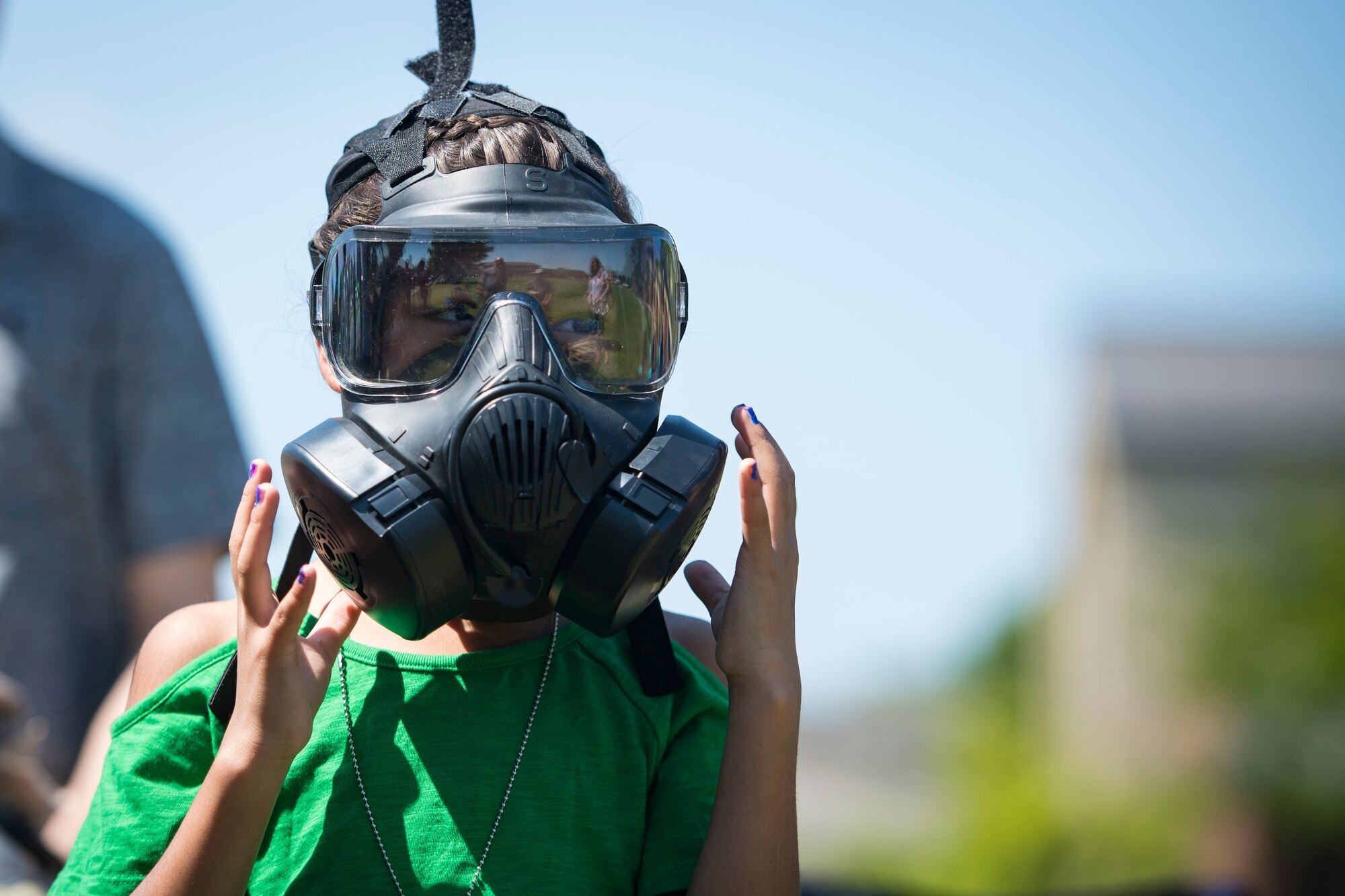 A participant tries on Mission Oriented Protective Posture or MOPP gear during the 2018 Kid’s Deployment Line, April 28, 2018, at Moody Air Force Base, Ga. The event allowed children the opportunity to experience what their parents go through while preparing to deploy. Children participated in obstacle courses, watched demonstrations and toured various aircraft and vehicles used by Airmen at Moody. (U.S. Air Force photo by Senior Airman Janiqua P. Robinson)