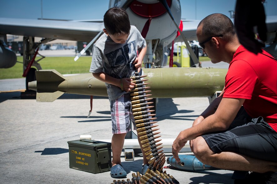A participant handles .50 caliber rounds during the 2018 Kid’s Deployment Line, April 28, 2018, at Moody Air Force Base, Ga.The event allowed children the opportunity to experience what their parents go through while preparing to deploy. Children participated in obstacle courses, watched demonstrations and toured various aircraft and vehicles used by Airmen at Moody. (U.S. Air Force photo by Senior Airman Janiqua P. Robinson)