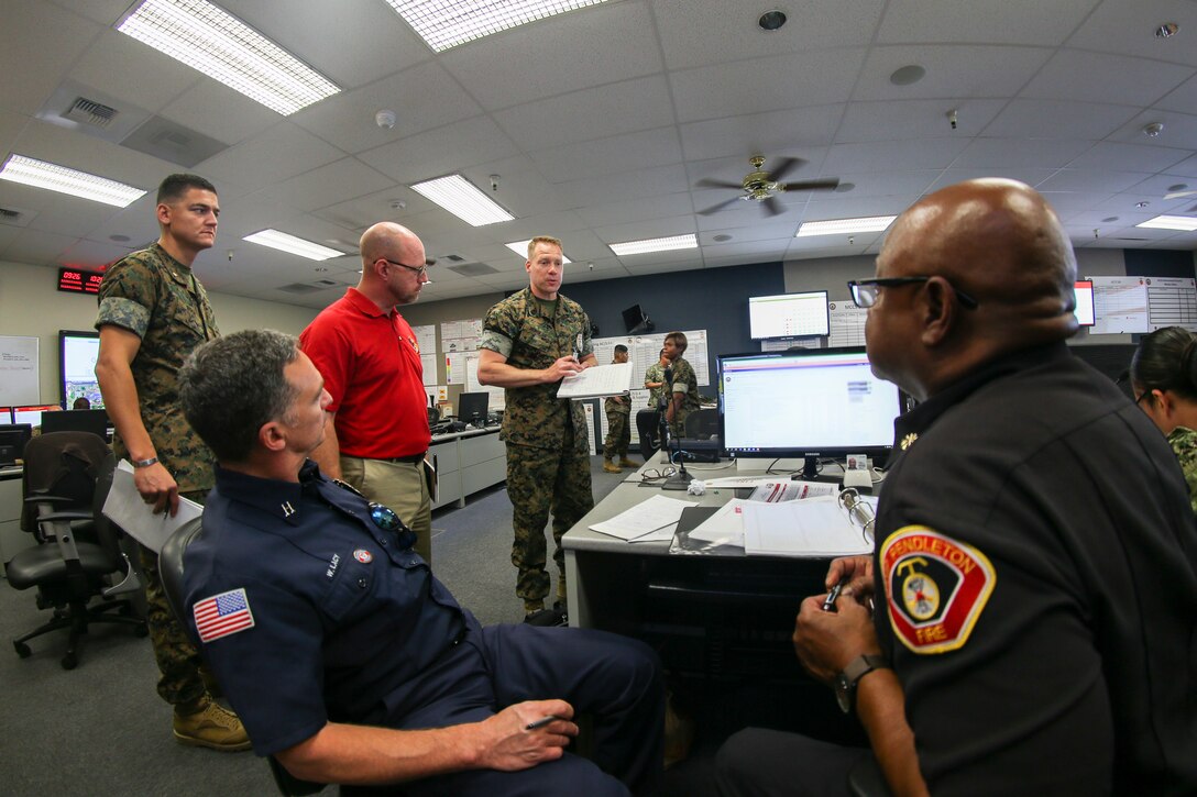 U.S. Marines and Department of Defense personnel communicate in an emergency operations center during a notional active shooter as part of Exercise Semper Durus on Camp Pendleton, Calif., April 25, 2018. Exercise Semper Durus exercises regional command and control during crisis situations to improve response procedures and limit impact while responding to possible terrorist activity.  (U.S. Marine Corps photo by Cpl. Dylan Chagnon)