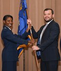 Maj. Jessica Sellers, commander of the 307th Force Support Squadron, presents the squadron flag to Brian Liesveld, the vice president of the Cyber Innovation Center, during an Honorary Commander’s Induction Ceremony on Barksdale Air Force Base, La. April 29, 2018.