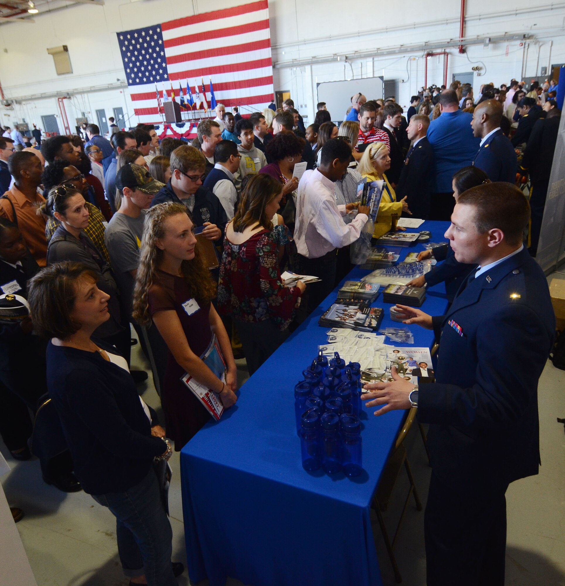 Attendees line up at a U.S. Air Force Academy information table at this year's Academy Day, held at Dobbins Air Reserve Base, Ga. April 28, 2018. U.S. military academies set up information tables for future applicants to ask questions about the application process. (U.S. Air Force photo/Don Peek)