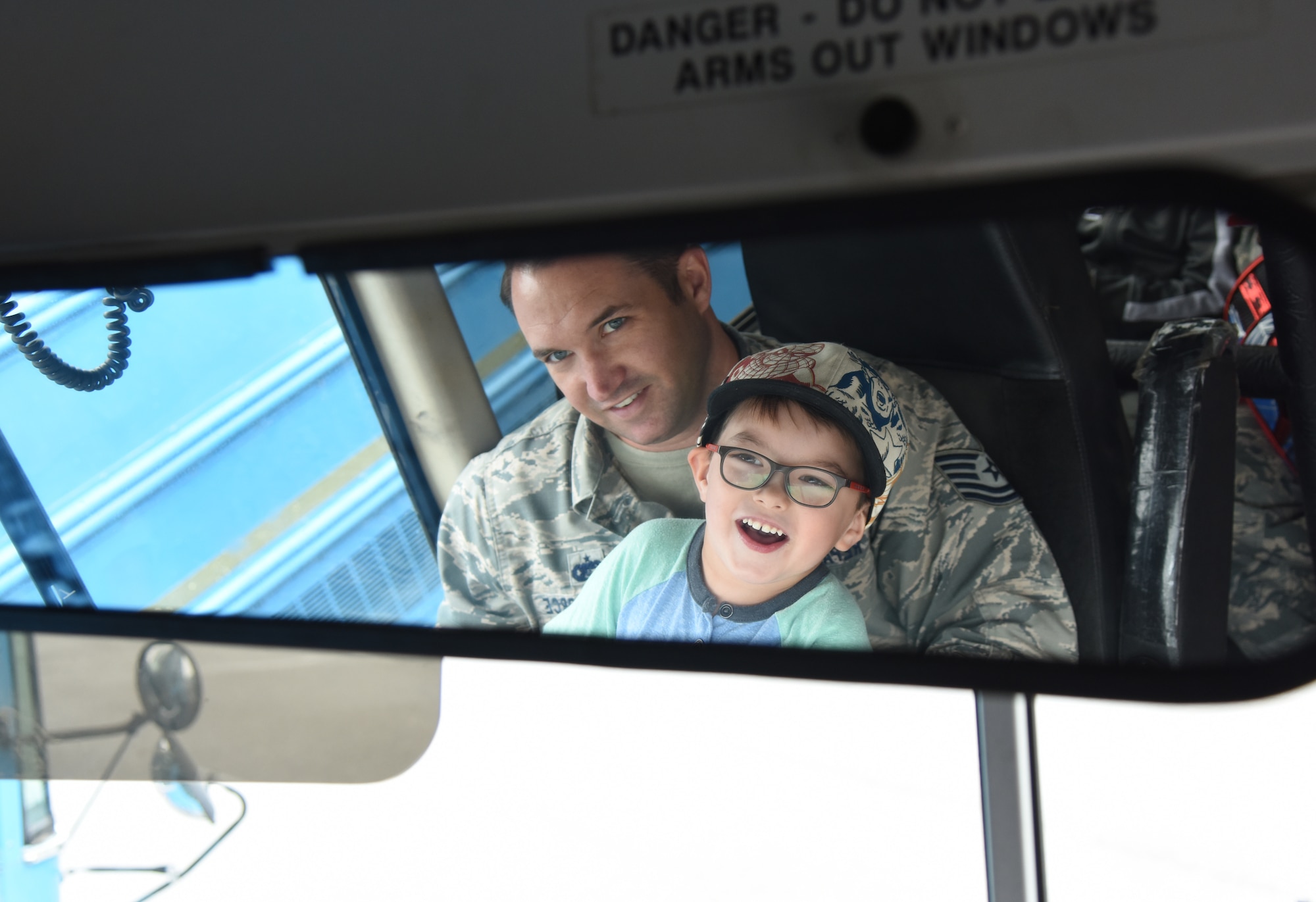 U.S. Air Force Tech. Sgt. Jason Repass, 81st Logistics Readiness Squadron vehicle operations control center supervisor, takes his son, Colton, on a bus tour during the 81st LRS Bring Your Child to Work Day event at the ground transportation yard at Keesler Air Force Base, Mississippi, April 26, 2018. The event allowed children the opportunity to experience what their parents do at work by touring facilities while receiving hands-on experiences. (U.S. Air Force photo by Kemberly Groue)