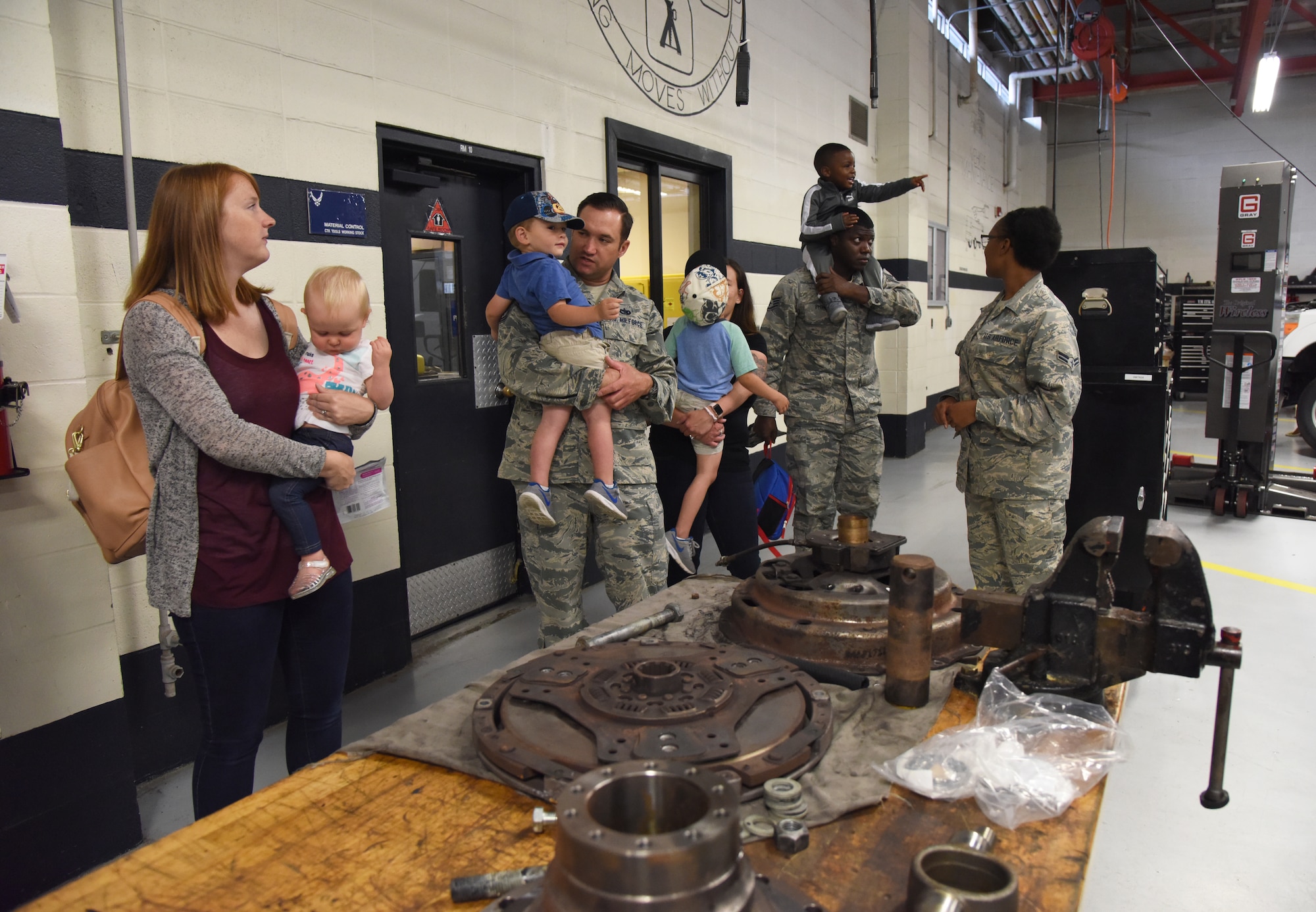 Members of the 81st Logistics Readiness Squadron take their children on a tour of the vehicle maintenance building during the 81st LRS Bring Your Child to Work Day event at Keesler Air Force Base, Mississippi, April 26, 2018. The event allowed children the opportunity to experience what their parents do at work by touring facilities while receiving hands-on experiences. (U.S. Air Force photo by Kemberly Groue)