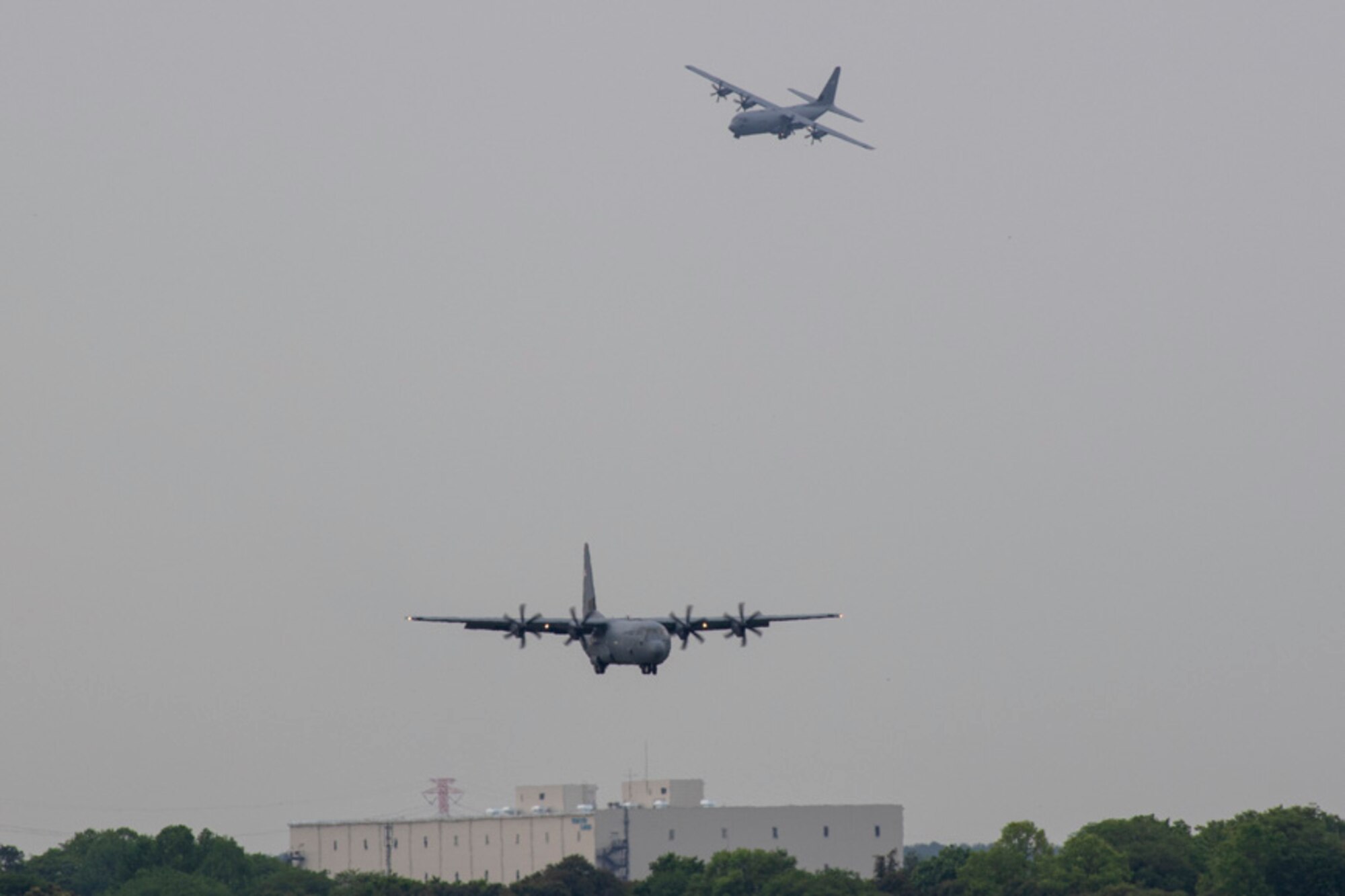 Two C-130J Super Hercules aircraft approach the runway at Yokota Air Base