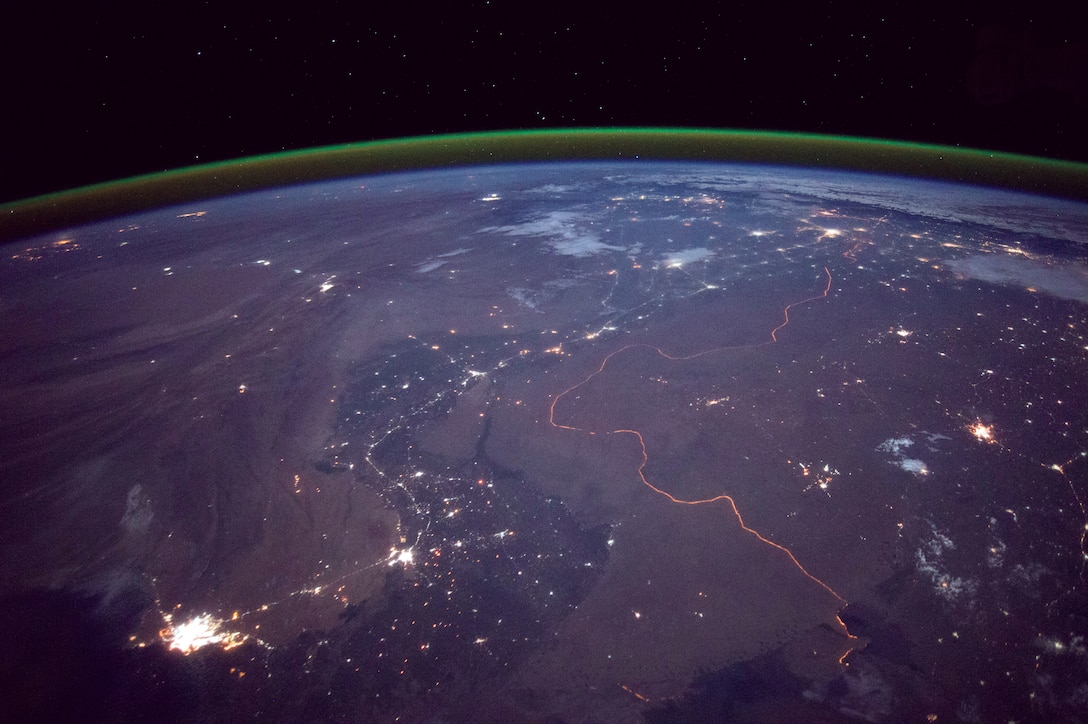 The India-Pakistan border is among the most heavily armed borders in the world; both countries possess nuclear weapons, including tactical nuclear weapons. The orange line snaking across the center of the image is a fenced floodlit border zone between India and Pakistan that is one of the few places on earth where an international boundary can be seen at night (NASA).