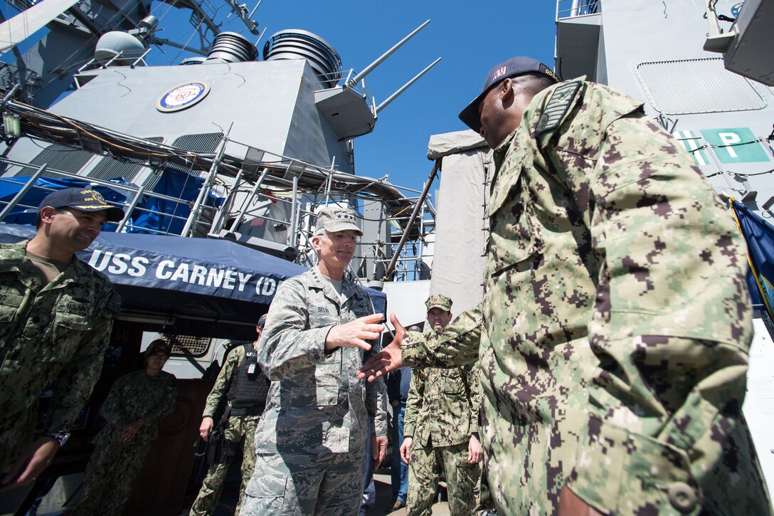 The vice chairman of the Joint Chiefs of Staff shakes hands with soldiers.