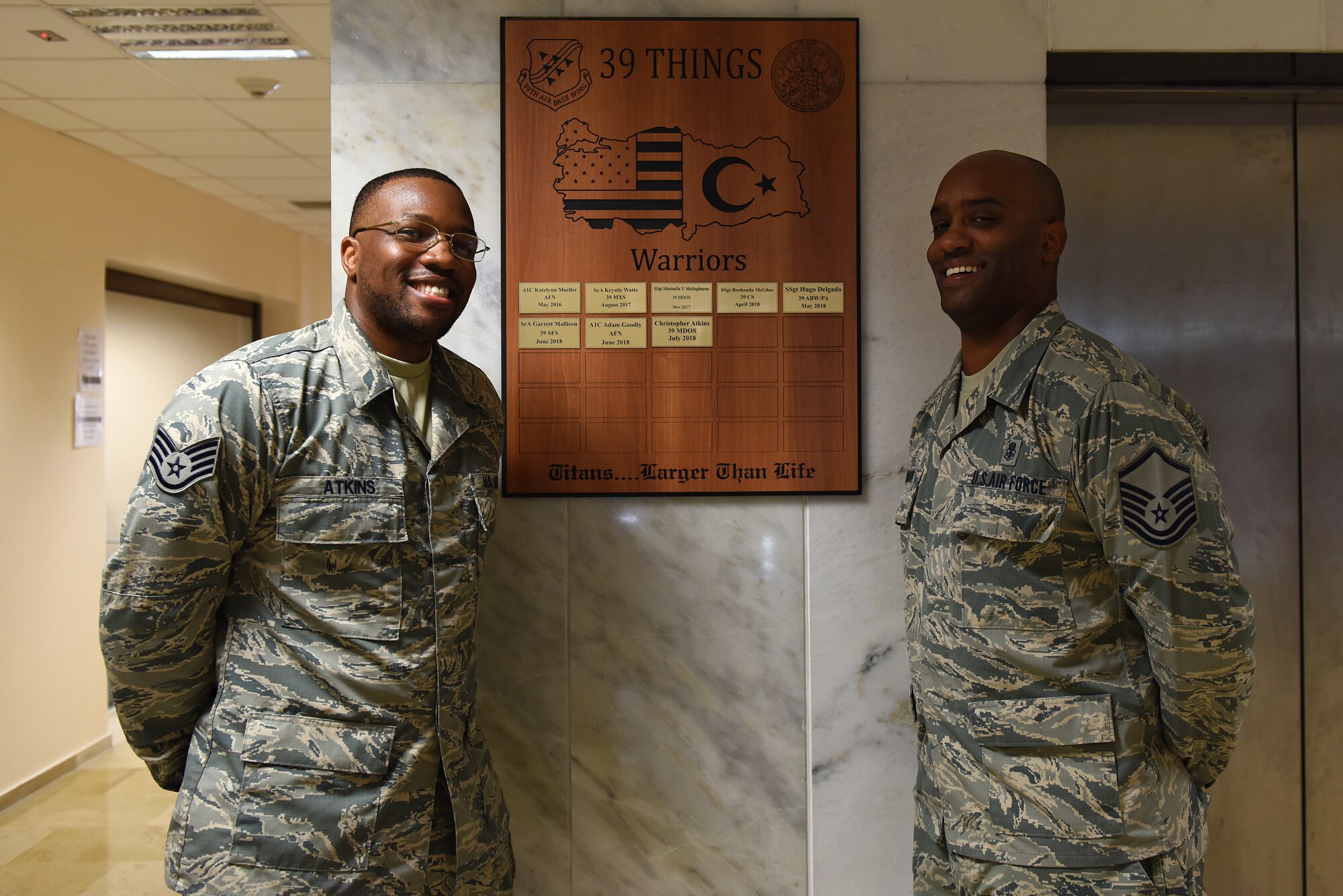 U.S. Air Force Master Sgt. Dexter Robinson poses with U.S. Air Force Staff Sgt. Christopher Atkins after Atkins' completion of the Titan University Warrior Program at Incirlik Air Base, Turkey, July 31, 2018.