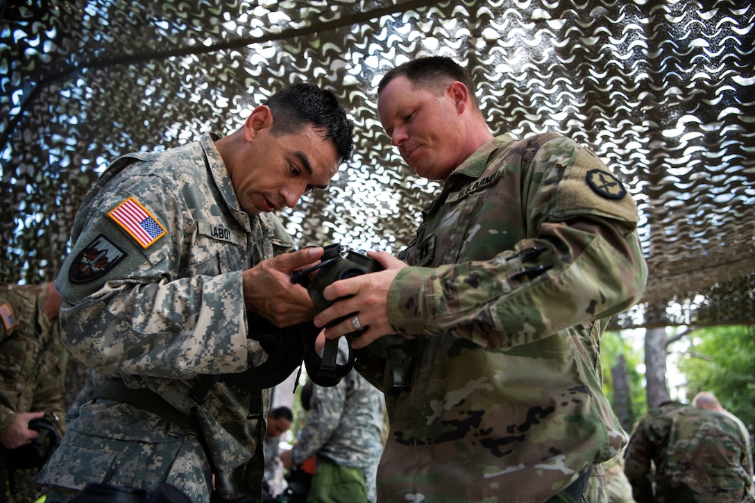 Two Army officers reassemble a protective mask during exercise Centurion Focus.