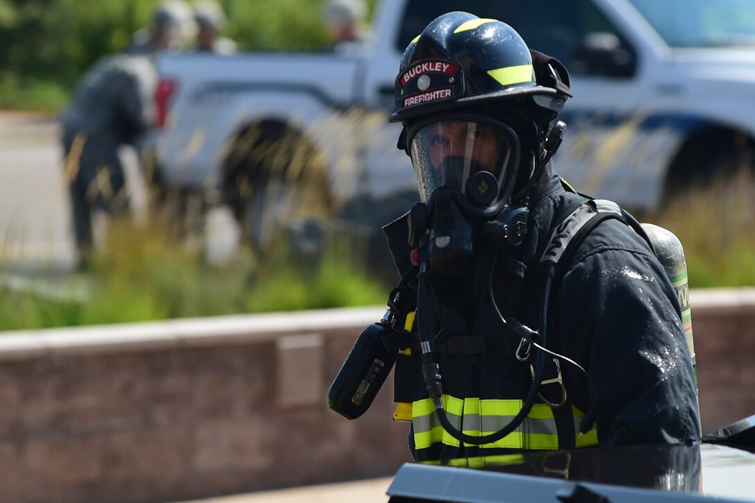 A firefighter extinguishes a car fire during Exercise Panther View.