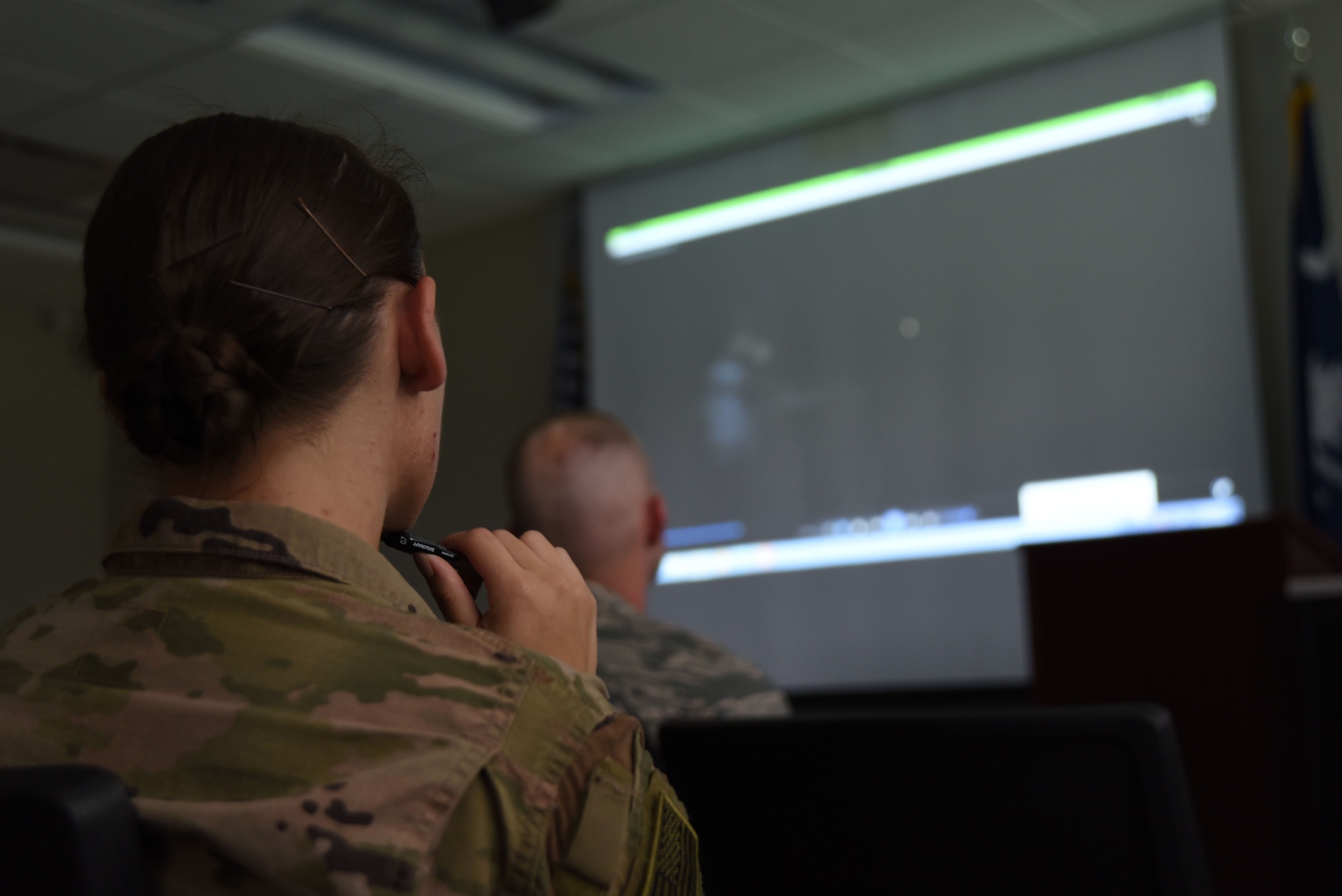 U.S. Airmen watch a video about the Air Force Office of Special Investigations (AFOSI) during an AFOSI recruiting team visit to the Spratt Education Center at Shaw Air Force Base, S.C., July 30, 2018.