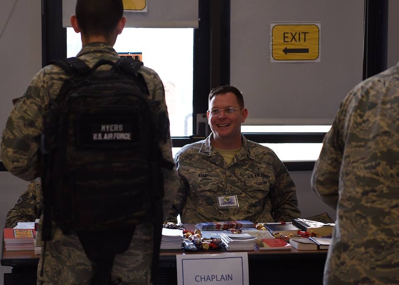 Chaplain Brian Kemp speaks with an airman in the pre-deployment line July 17, 2018 at the PAX Terminal on Patrick Air Force Base, Fla. The Chapel was one of the units supporting the PDF line and providing inspirational text, trinkets and religious materials to those deploying. (U.S. Air Force photo by Airman 1st Class Zoe Thacker)