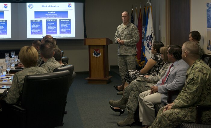 U.S. Air Force Lt. Col. Trevor Schar, 628th Medical Group deputy commander, presents slides during a mission brief for the Defense Health Agency and Air Force Surgeon General July 30, 2018, at Joint Base Charleston. The group visited JB Charleston to better understand the unique mission sets of the base and the needs of beneficiaries served by the 628th Medical Group.