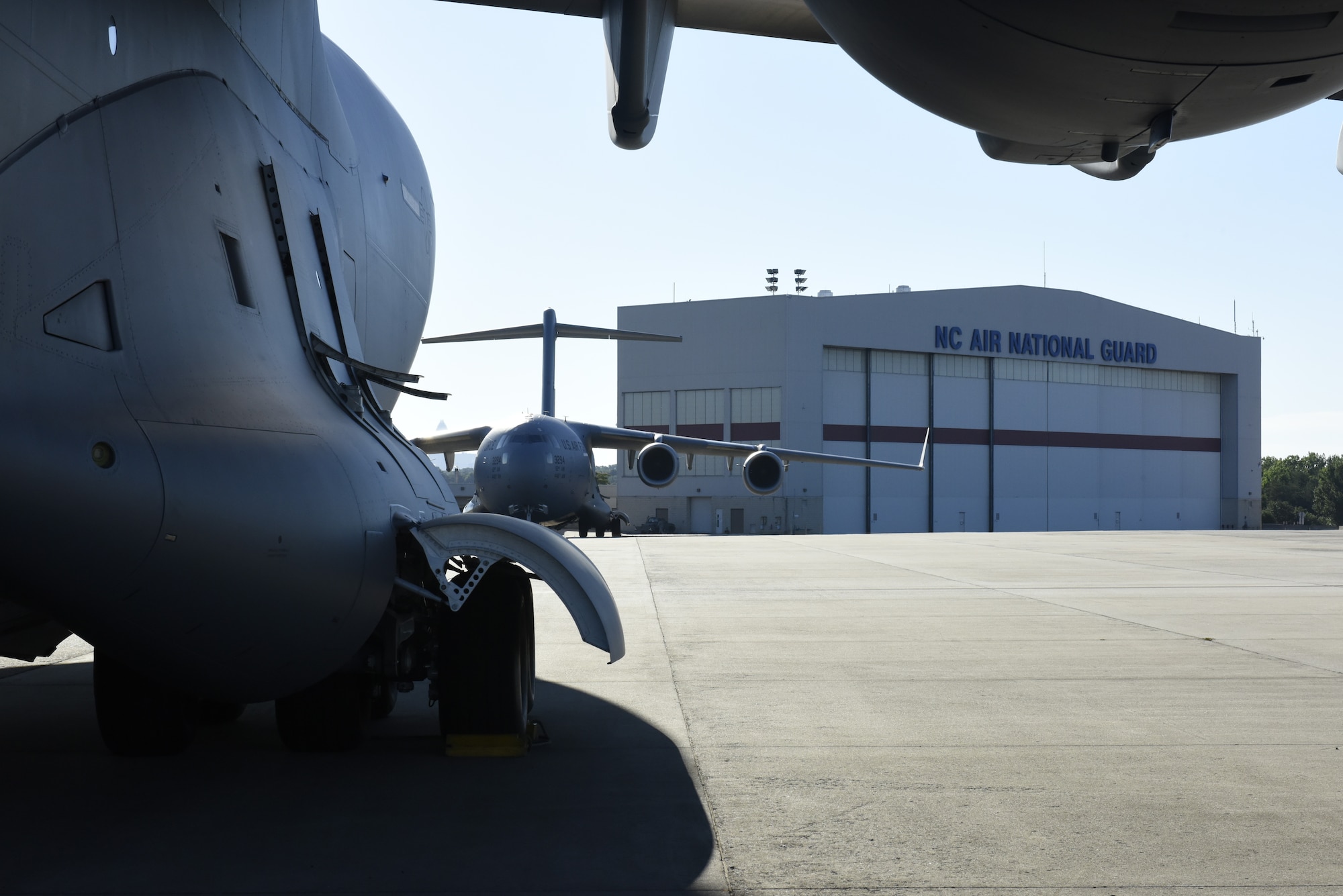 A North Carolina Air National Guard C-17 Globemaster III Aircraft sits on the flight line as it is prepped to transport Airmen and equipment from the 156th Aeromedical Evacuation Squadron from North Carolina Air National Guard Base, Charlotte Douglas International Airport, to Volk Field Air National Guard Base, Wisconsin, for a training exercise, July 9, 2018. (U.S. Air Force photo by Tech. Sgt. Nathan Clark)