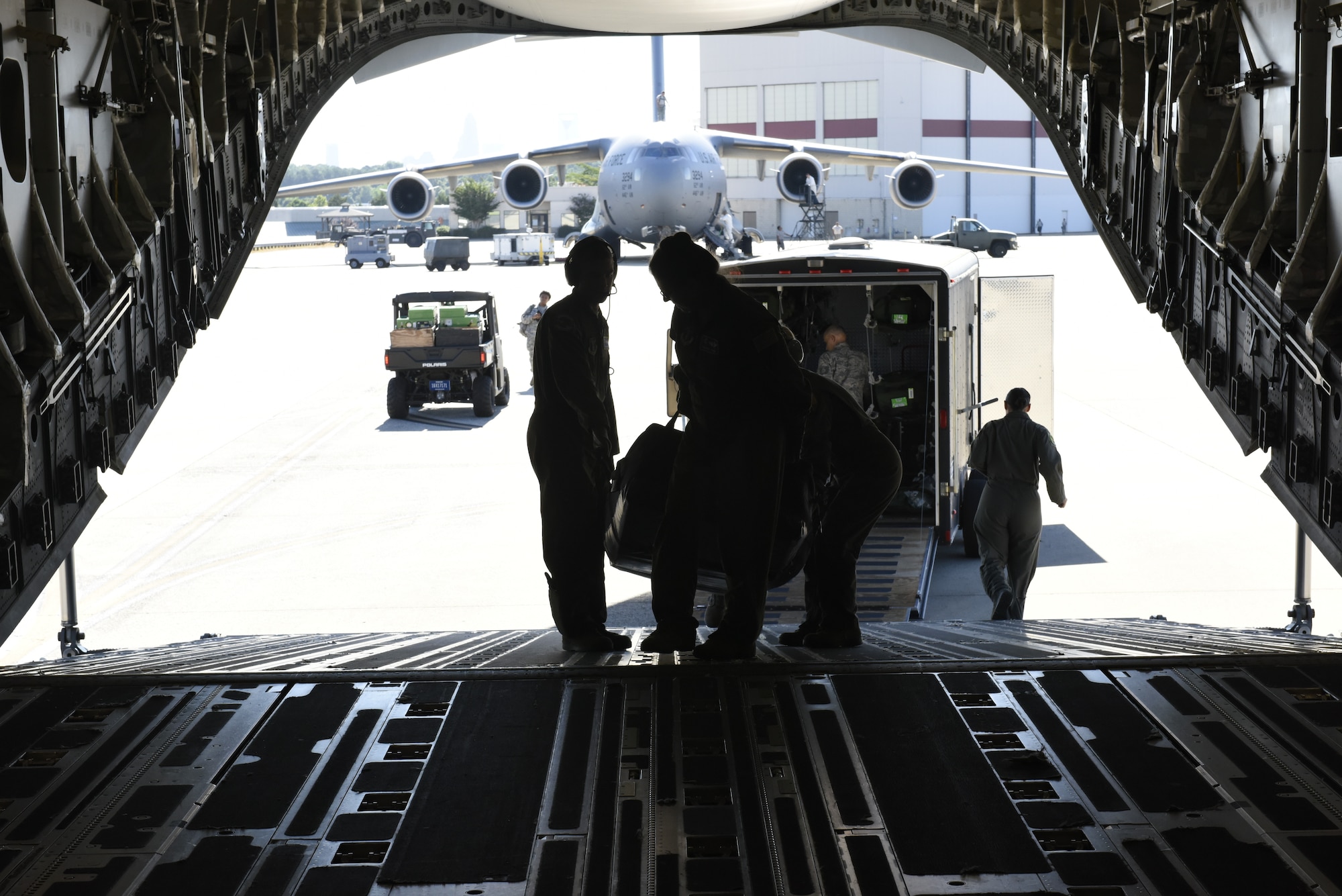 Airmen from the 156th Aeromedical Evacuation Squadron load medical equipment aboard a C-17 Globemaster III aircraft, for transport from North Carolina Air National Guard Base, Charlotte Douglas International Airport to Volk Field Air National Guard Base, Wisconsin, for a training exercise, July 9, 2018. (U.S. Air Force photo by Tech. Sgt. Nathan Clark)