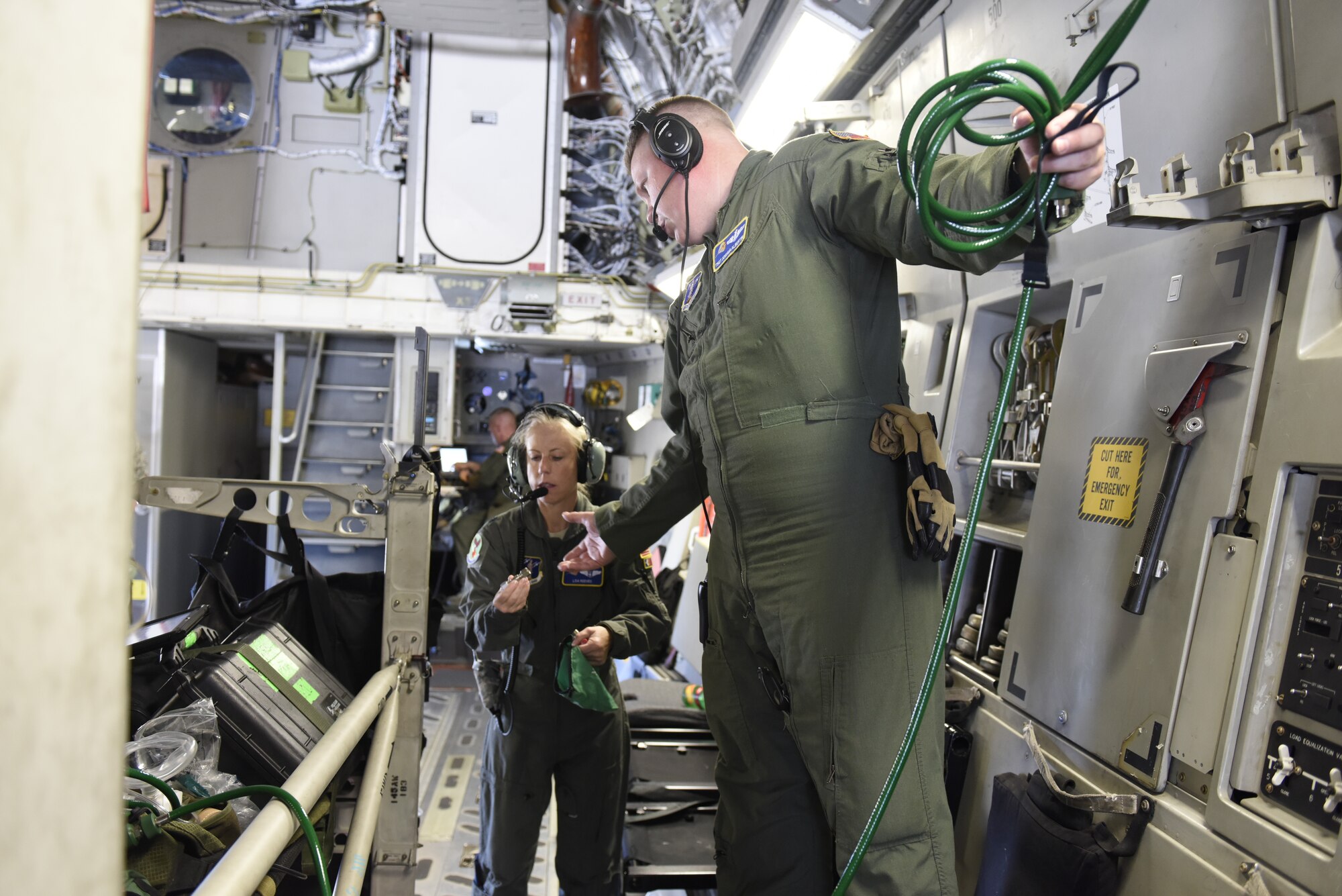 U.S. Air Force Lt. Col. Lisa Reeves (left) and Tech. Sgt. Joshua Albertin, members of the 156th Aeromedical Evacuation Squadron, attach important medical equipment to a North Carolina Air National Guard C-17 Globemaster III prior to taking off from North Carolina Air National Guard Base, Charlotte Douglas International Airport, for transport to Volk Field Air National Guard Base, Wisconsin, for a training exercise, July 9, 2018. (U.S. Air Force photo by Tech. Sgt. Nathan Clark)