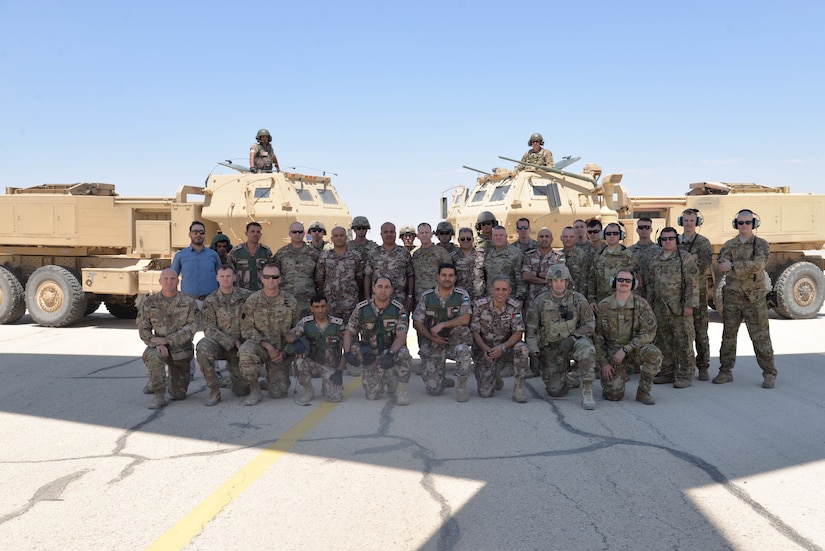 Soldier with Task Force Spartan and the Jordanian Army’s 29th Royal HIMARS Battalion pose for a group photo after the launch of a Guided Multiple Launch Rocket from a Jordanian M142 High Mobility Artillery Rocket System (HIMARS) on July 23, 2018 during the Operation Lion Flight bi-lateral live-fire training exercise.