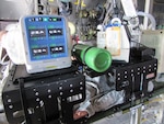 The multi-channel wound vacuum system is tested on a simulated patient in a C-130 static aircraft display at the 59th Medical Wing, San Antonio, Texas, Dec. 1, 2016. The multi-channel wound vacuum system, which is used to promote wound healing on critical patients, is able to replace the capabilities of four single-channel systems. This smaller, more transportable device makes it easier for aeromedical evacuation crews to deliver en route wound care to patients with multiple wounds. The Air Force Medical Evaluation Support Activity (AFMESA) team was involved in the testing of the multi-channel wound vacuum system, ensuring the device could perform in the operational environment.