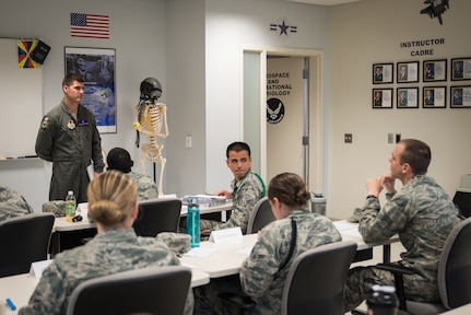 Staff Sgt. William Ensrud, aerospace physiology technician and assistant course director for aerospace and operational physiology apprentice course, listens to a student’s question during the course. (U.S. Air Force photo by Richard  Eldridge)