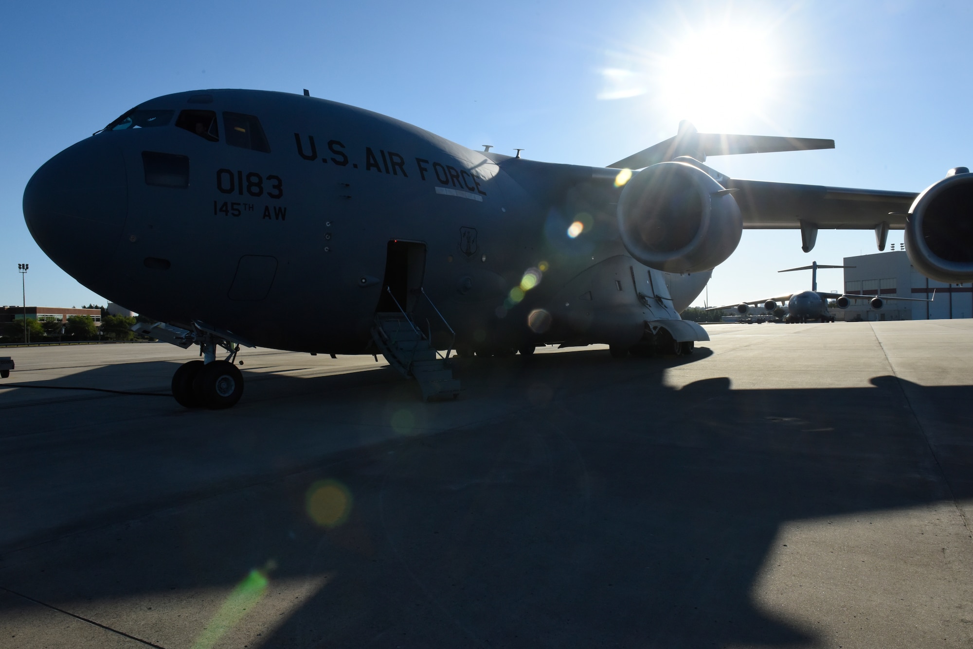 A North Carolina Air National Guard C-17 Globemaster III aircraft sits on the flight line at North Carolina Air National Guard Base, Charlotte Douglas International Airport, as it is prepped for one of its first missions with the 145th Airlift Wing, July 9, 2018. The flight carried members of the 156th Aeromedical Evacuation Squadron to Volk Field Air National Guard Base, Wisconsin, for a training exercise. (U.S. Air Force photo by Tech. Sgt. Nathan Clark)