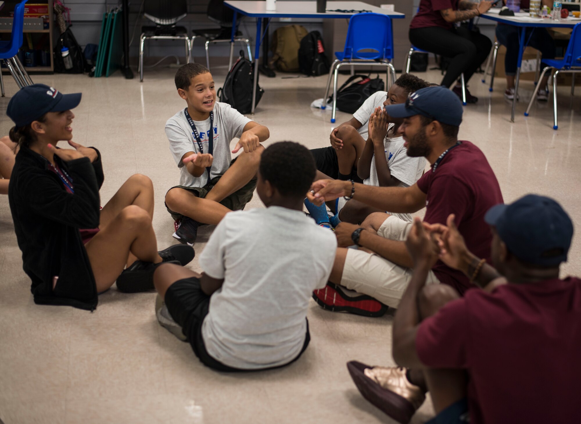 Drug Education for Youth (D.E.F.Y) program youth and volunteers play a game to bolster communication skills, July 26, 2018, at MacDill Air Force Base, Fla.
