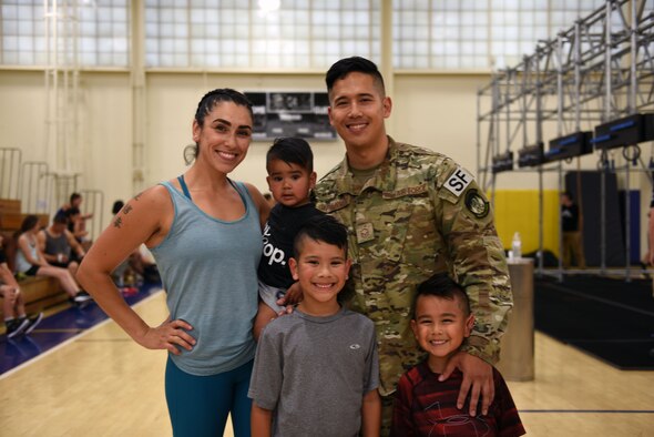 Master Sgt. Christofer Galbadores, 821st Contingency Response Squadron force protection flight chief, stands with his wife, Yasmin, and their three sons, Cain, Maximus and Kingston July 23 at Travis Air Force Base, Calif. The Galbadores couple both ran on the Alpha Warrior "big rig" while their sons watched them from the crowd. (U.S. Air Force photo by Airman 1st Class Christian Conrad)