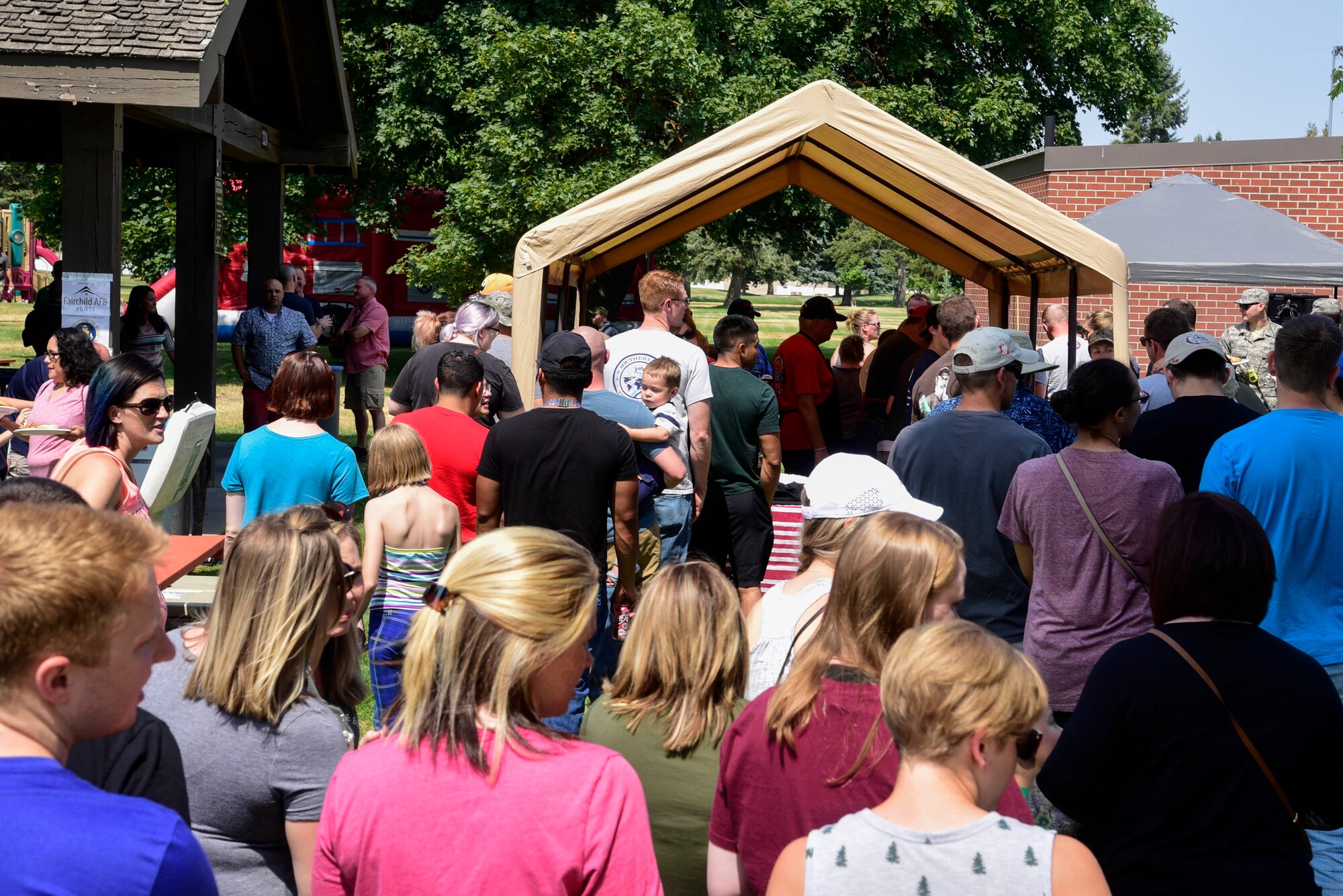 Team Fairchild Airmen line up to receive free barbeque July 28, 2018 at Fairchild Air Force Base, Washington. More than 200 Airmen and their families attended the free-food event that included a corn-hole tournament, kid’s games, water-balloon toss and a three-legged race. (U.S. Air Force photo/Staff Sgt. Nick Daniello)