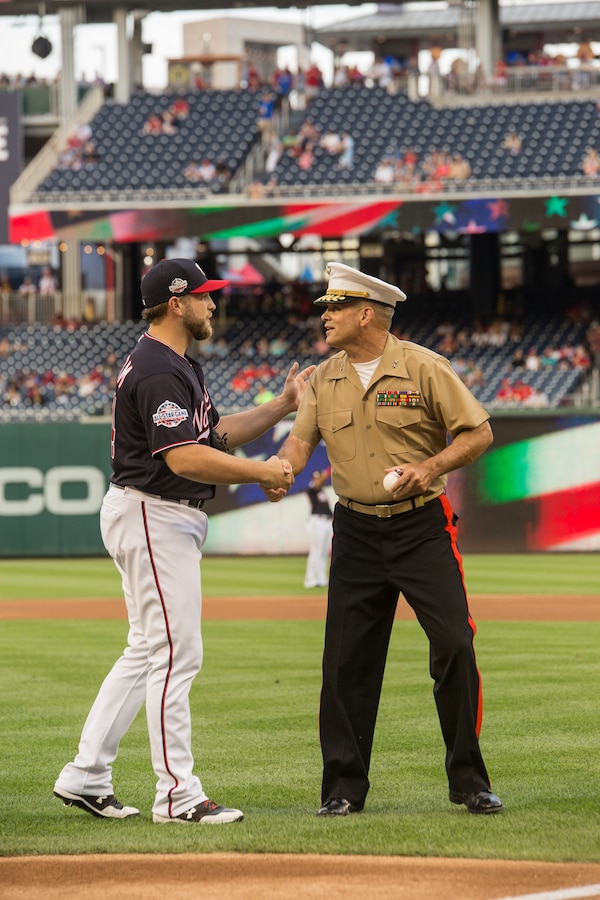 Major Gen. John R. Ewers Jr., staff judge advocate to the Commandant of the Marine Corps, shakes the hand of Washington Nationals catcher, Spencer Kieboom, during U.S. Marine Corps Day at Nationals Park, Washington D.C., July 31, 2018. The Washington Nationals hosted Marines stationed around the National Capital Region to participate in pre-game events to honor the Marine Corps. (Official U.S. Marine Corps photo by Sgt. Robert Knapp/Released)