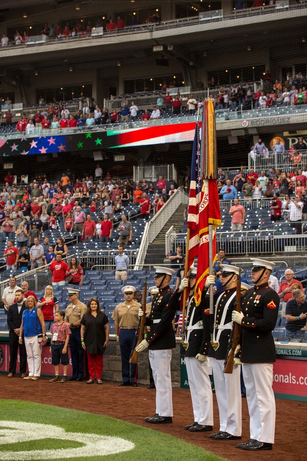 Marines with the U.S. Marine Corps Color Guard prepare to present the National Ensign during the playing of the National Anthem at U.S. Marine Corps Day at Nationals Park, Washington D.C., July 31, 2018. The Washington Nationals hosted Marines stationed around the National Capital Region to participate in pre-game events to honor the Marine Corps. (Official U.S. Marine Corps photo by Sgt. Robert Knapp/Released)