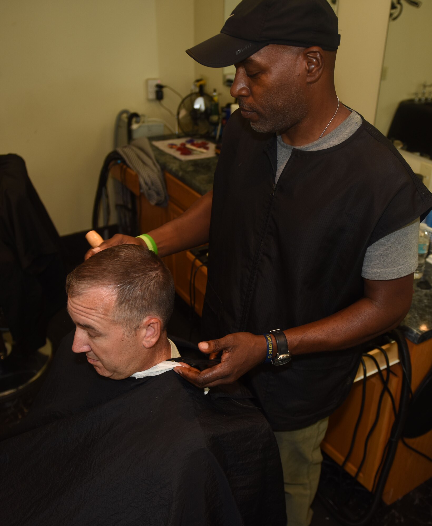 Donald Eady, 20th Force Support Squadron barber, cuts a Team Shaw member’s hair at Shaw Air Force Base, S.C., July 31, 2018.