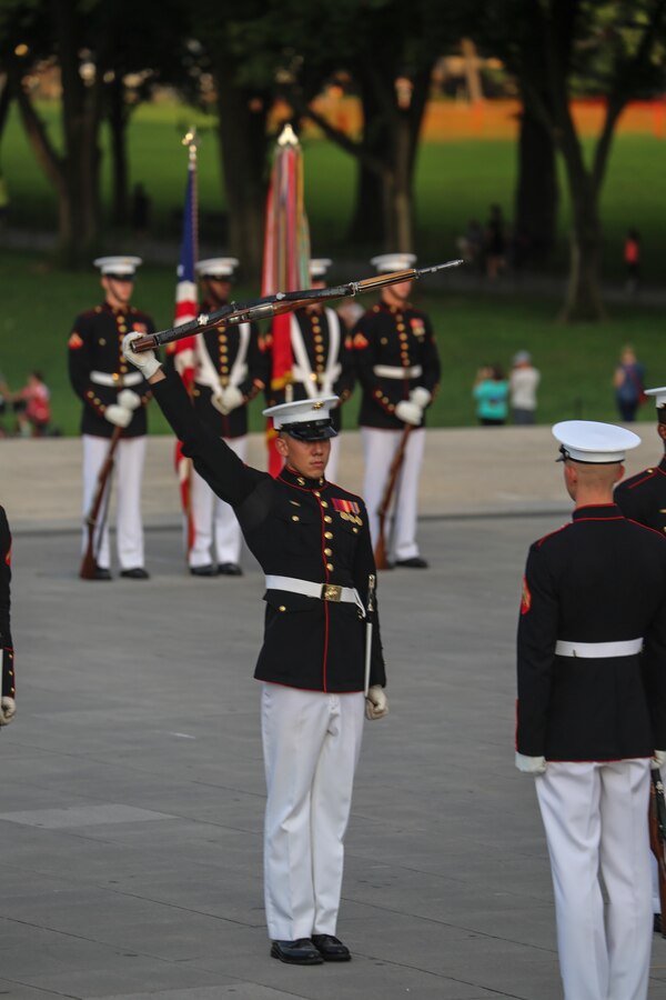 Corporal Darius Mick, rifle inspection team, U.S. Marine Corps Silent Drill Platoon, executes precision rifle drill movements during a Tuesday Sunset Parade at the Lincoln Memorial, Washington D.C., July 31, 2018. The guest of honor for the parade was Dana White, assistant to the Secretary of Defense for Public Affairs, and the hosting official was Brig. Gen. William Seely III, director, Office of Marine Corps Communications. (Official U.S. Marine Corps Photo by Cpl. Damon Mclean/Released)