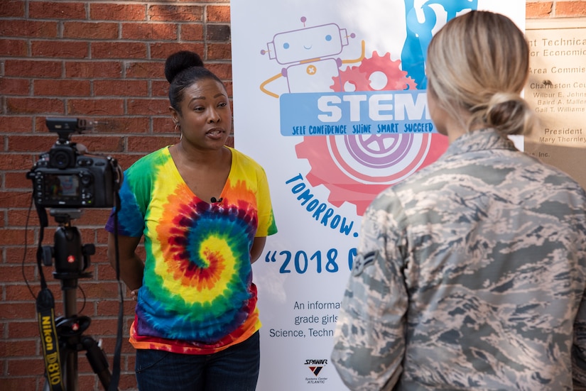 Anishi Scott, Space and Naval Warfare Systems Center Atlantic computer scientist and camp co-coordinator, conducts an interview with Airman 1st Class Jill Neufeld, Joint Base Charleston Public Affairs broadcaster, July 26, 2018, during the seventh Annual Girls Day out at Trident Technical College.