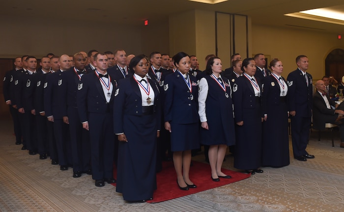Fifty-three Joint Base Charleston noncommissioned officers along with family and friends, joined in celebrating the installation's newest Senior NCOs at the Charleston Club, July 27, 2018. The Senior NCO Induction Ceremony is a long-standing tradition within the Air Force to recognize the achievement of reaching the rank of master sergeant. There are three main components to an induction ceremony: posting of the colors; the charge and oath; and the candle-lighting ceremony. These Senior NCOs must promote the highest standards of conduct, appearance and performance. As part of this tradition, a candle-lighting ceremony was conducted. Each candle represented one of the nine enlisted ranks of the Air Force. Members of each rank were called upon to light their respective candles. (U.S. Air Force photos by Staff Sgt. Andrea Salazar)