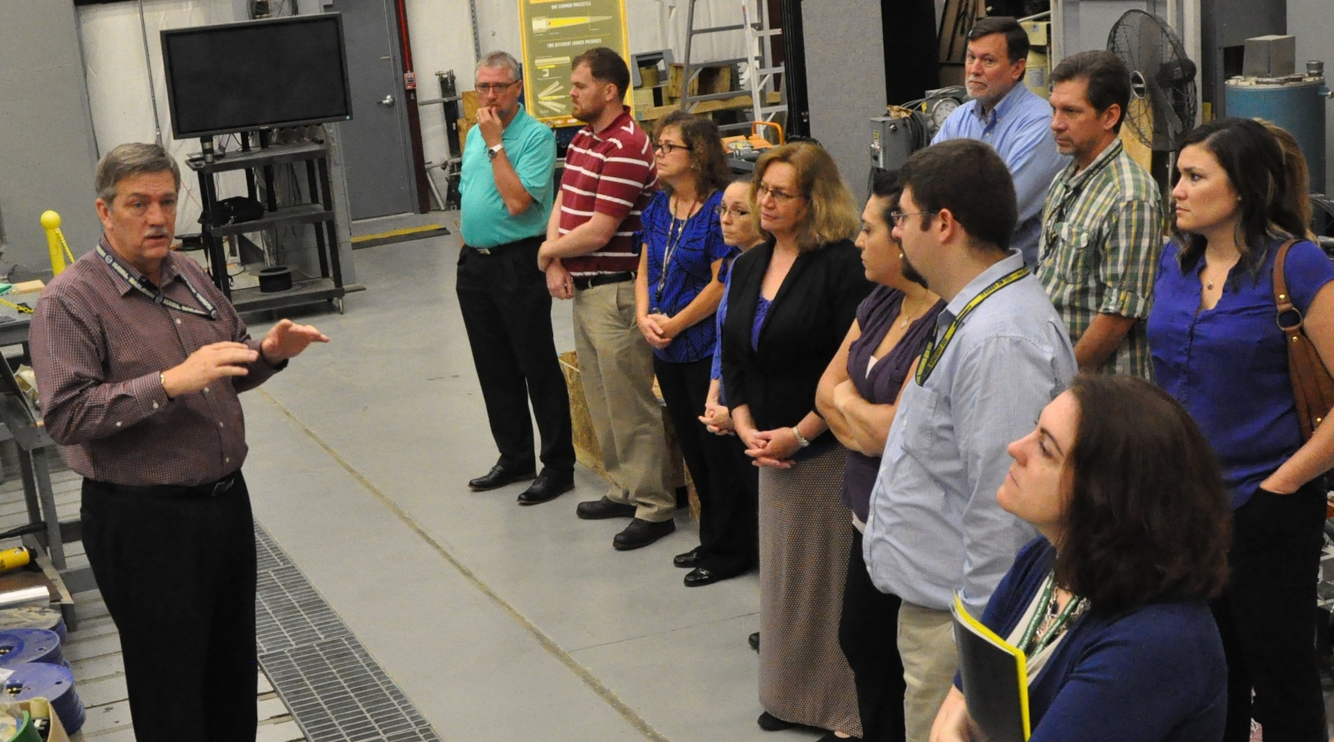 IMAGE: DAHLGREN, Va. (June 21, 2018) - Propel students review the Electromagnetic Railgun design parameters and test operations during a tour of the NSWC Dahlgren Division Electromagnetic Launch Facility conducted by Chester Petry, Chief Engineer for Electromagnetic Launch Weapons.  The Propel students discussed the use of electric weapons on future Navy combatants where the need for electric power will continue to grow and improve combat capability. Petry briefed the Warfare Centers' new supervisors during their tour of Dahlgren that included the Potomac River Test Range and the Human Performance Laboratory in addition to the Railgun Facility. The five-day Propel course provides an introductory level awareness of Warfare Center expectations and teaches a whole person supervisory approach that focuses on understanding supervisory responsibilities, practicing soft skills, and knowing where to go for situationally specific human resources support.  (U.S. Navy photo/Released)