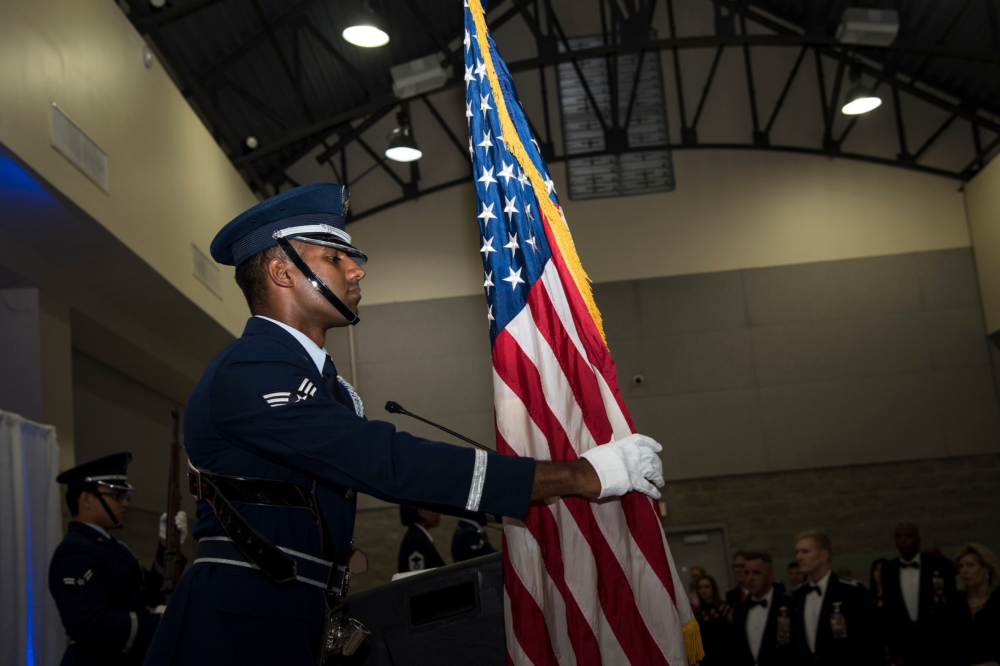 An Airman from Moody’s Honor Guard presents the colors during a Senior NCO Induction ceremony, July 27, 2018, in Valdosta, Ga. The ceremony honored Moody’s upcoming and newest Senior NCOs as they join the ranks of the highest enlisted tier. Senior NCOs lead and manage teams, provide guidance to leadership, translate leaders’ decisions into specific tasks, and help Airmen internalize the Air Force core values. (U.S. Air Force photo by Airman 1st Class Eugene Oliver)