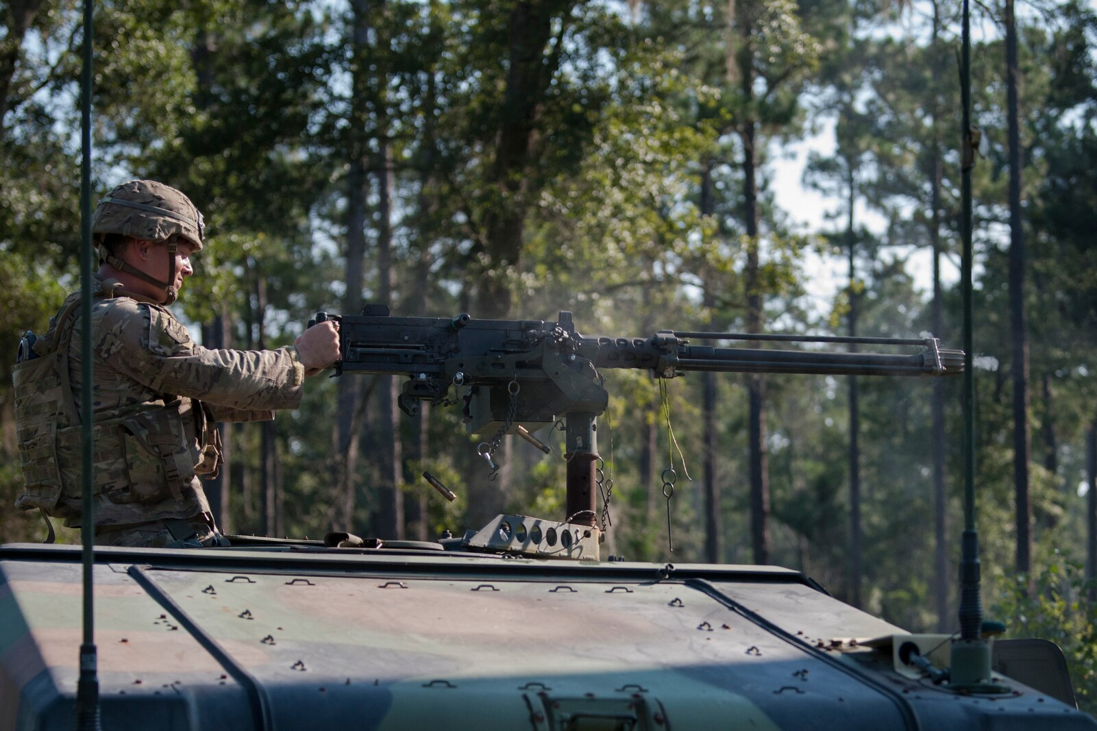 An Airman from the 822d Base Defense Squadron (BDS) fires an M2 machine gun during a full mission profile assessment, July 24, 2018, at Moody Air Force Base, Ga. The ‘Safeside’ defenders evaluated their base defense tactics and procedures while performing patrols, tactical combat casualty care and countering improvised explosive devices for a mission readiness exercise. After successfully completing these events, the defenders are eligible to earn their Global Response Force status, which certifies the unit to deploy worldwide. (U.S. Air Force photo by Airman Taryn Butler)