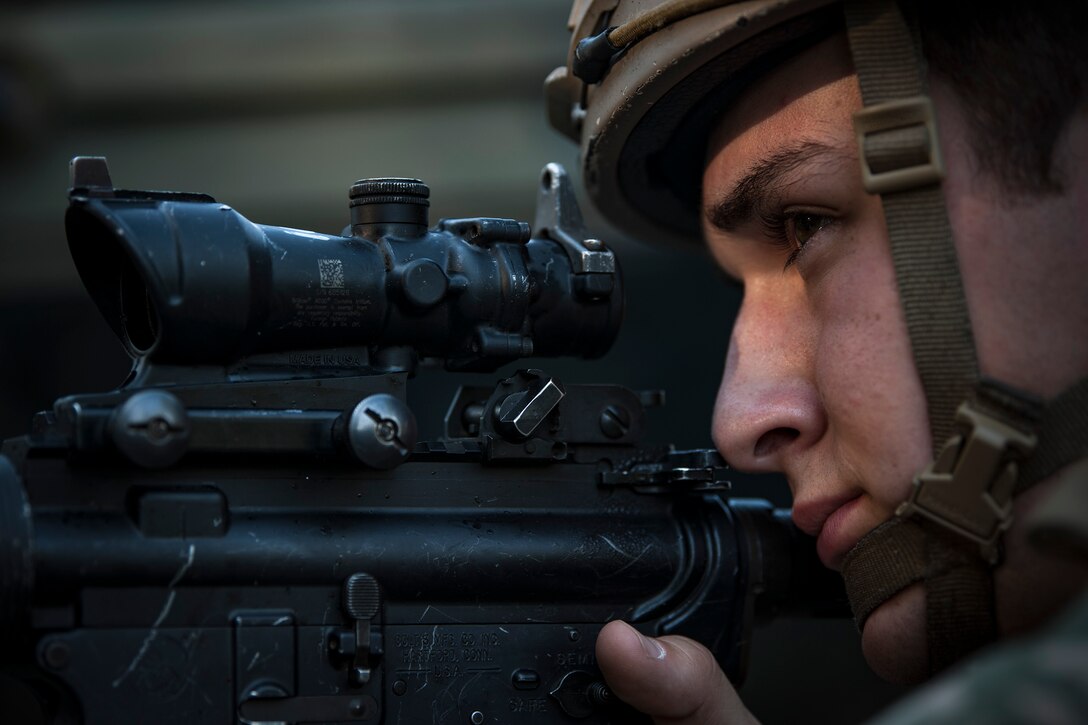 An Airman from the 822d Base Defense Squadron (BDS) aims down his sights during a full mission profile assessment, July 24, 2018, at Moody Air Force Base, Ga. The ‘Safeside’ defenders evaluated their base defense tactics and procedures while performing patrols, tactical combat casualty care and countering improvised explosive devices for a mission readiness exercise. After successfully completing these events, the defenders are eligible to earn their Global Response Force status, which certifies the unit to deploy worldwide. (U.S. Air Force photo by Airman Taryn Butler)