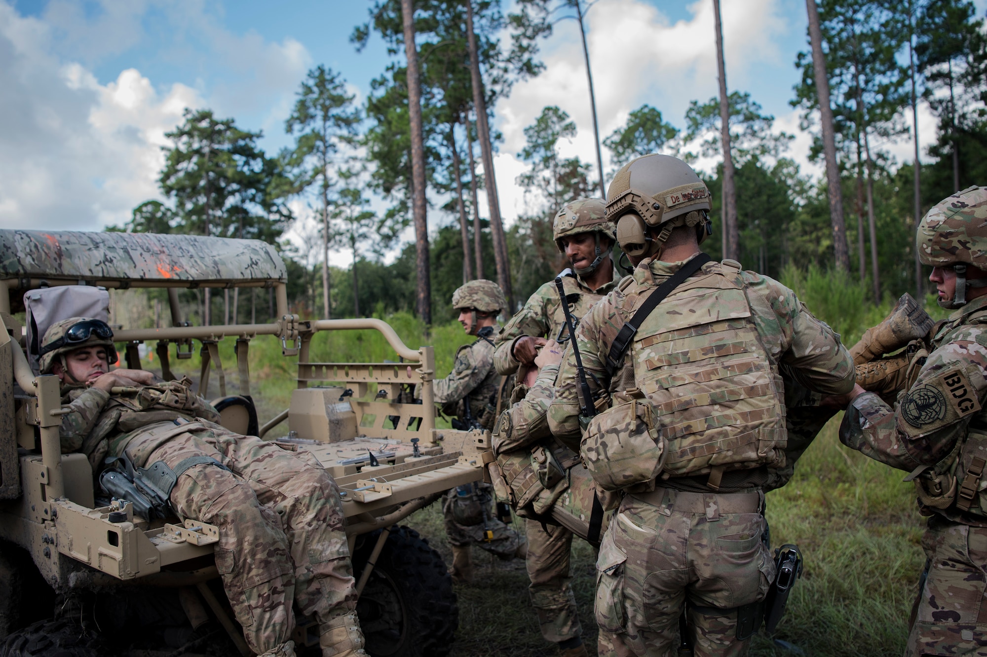 Airmen from the 822d Base Defense Squadron (BDS) place a simulated injured Airman on the back of a military RZR all-terrain vehicle during a full mission profile assessment, July 24, 2018, at Moody Air Force Base, Ga. The ‘Safeside’ defenders evaluated their base defense tactics and procedures while performing patrols, tactical combat casualty care and countering improvised explosive for a mission readiness exercise. After successfully completing these events, the defenders are eligible to earn their Global Response Force status, which certifies the unit to deploy worldwide. (U.S. Air Force photo by Airman Taryn Butler)