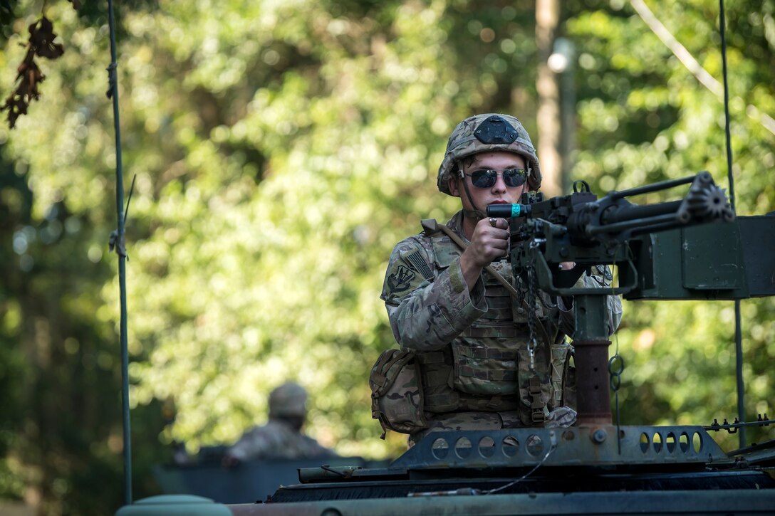 An Airman from the 822d Base Defense Squadron aims down the sights of an M2 machine gun, July 25, 2018, at Moody Air Force Base, Ga. The ‘Safeside’ defenders evaluated their base defense tactics and procedures while performing patrols, tactical combat casualty care and countering improvised explosive devices for a mission readiness exercise. After successfully completing these events, the defenders are eligible to earn their Global Response Force status, which certifies the unit to deploy worldwide. (U.S. Air Force photo by Airman 1st Class Eugene Oliver)