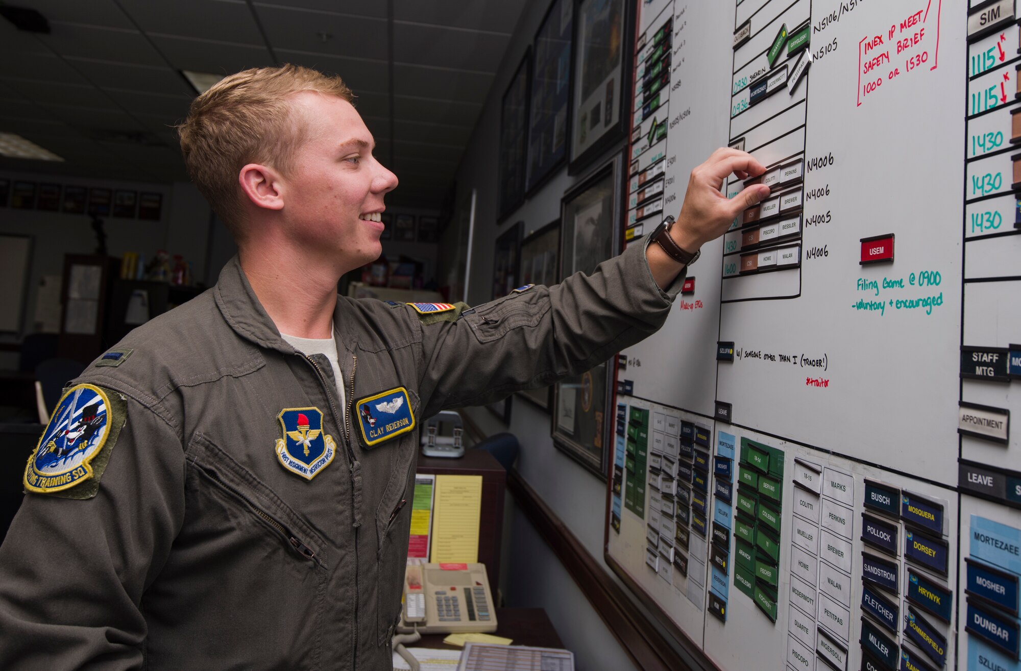 First Lieutenant Clay Reierson, 86th Flying Training Squadron instructor pilot and flight scheduler, manages the schedule board in his classroom, July 24, 2018 at Laughlin Air Force Base, Texas. Reierson explained that the growing student undergraduate pilot training class sizes provide greater opportunities to fly, but they also demand instructor pilots and students alike to be diligent with time management. (U.S. Air Force photo by Airman 1st Class Anne McCready)