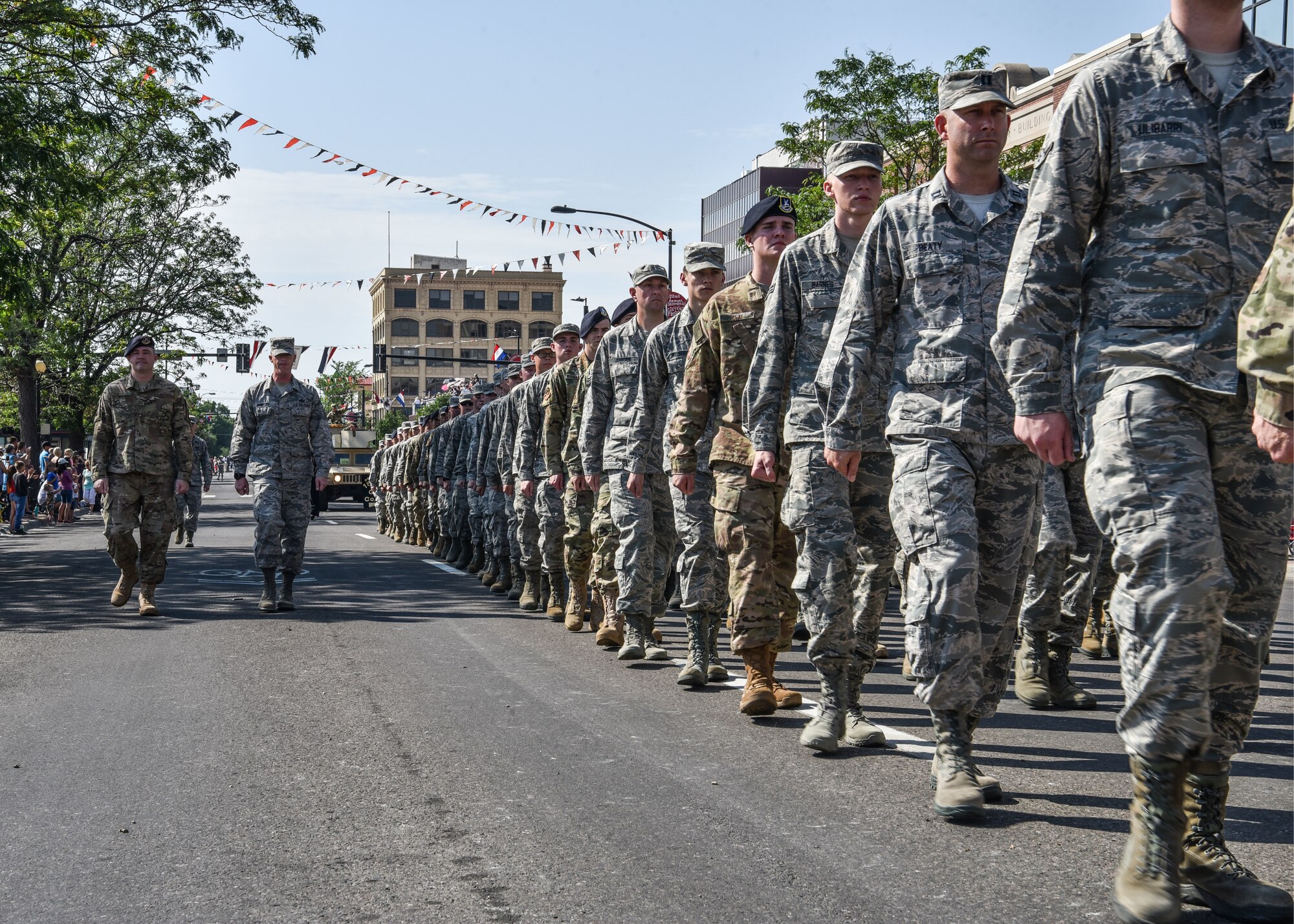 Airmen from F.E. Warren Air Force Base, Wyo., march in formation during the 122nd Cheyenne Frontier Days Grand Parade in Cheyenne, Wyo., July 21, 2018. Service members from multiple branches took part in the parade. This year marks the 151st anniversary of F.E. Warren Air Force Base and the city of Cheyenne. (U.S. Air Force photo by Airman 1st Class Braydon Williams)