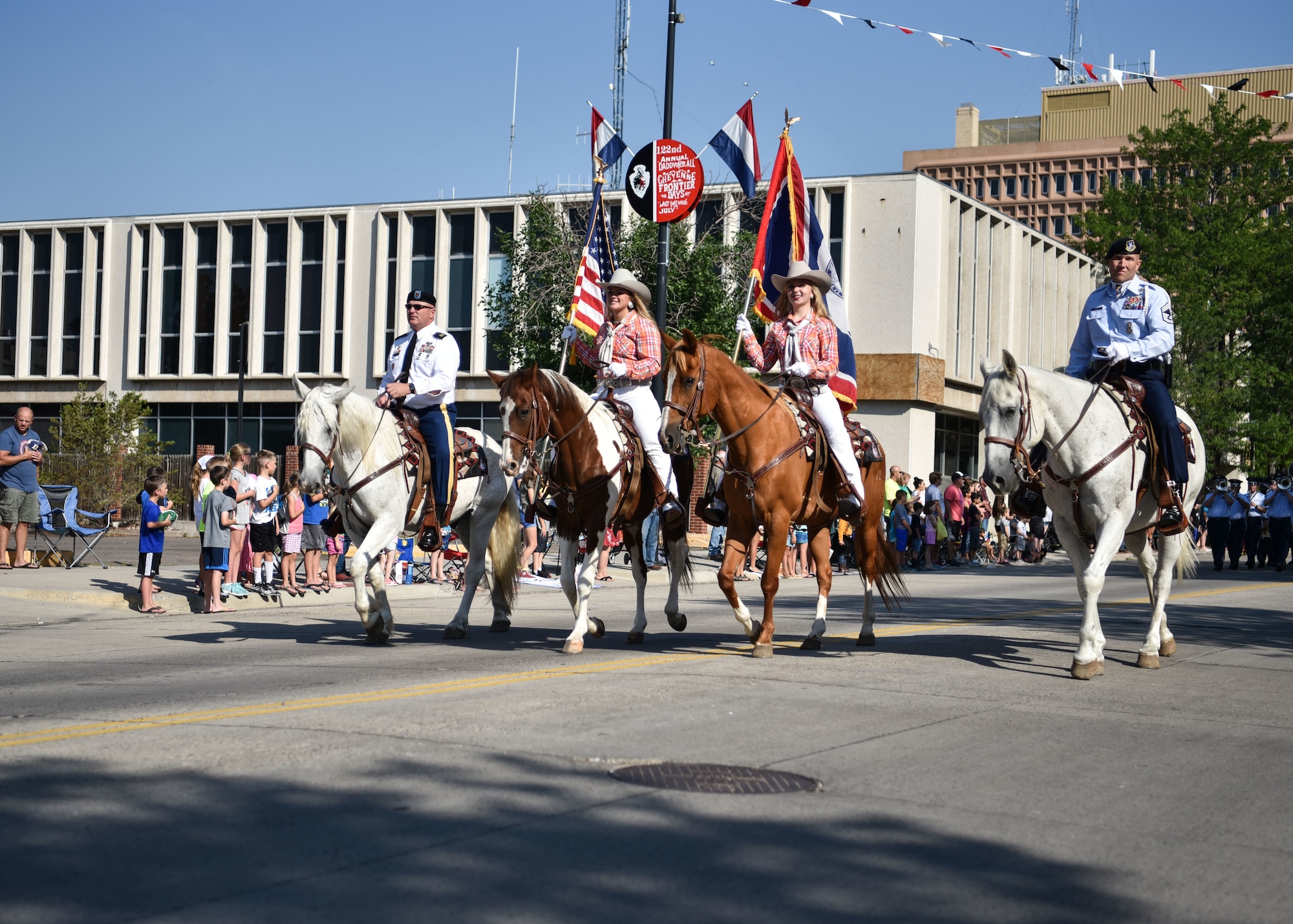 Military personnel and civilian ride together July 21, 2018, during the Cheyenne Frontier Days Grand Parade, Cheyenne Wyo. The Cheyenne community and F.E. Warren Air Force Base have been working together for 122 years to keep ‘the Daddy of ‘em All’ running smoothly. (U.S. Air Force photo by Airman 1st Class Braydon Williams)