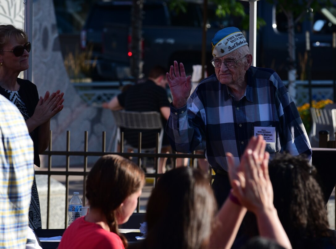 Steve Warren, the last living survivor of Pearl Harbor in South Dakota, stands as he is recognized at the 32nd Annual Military Affairs Committee Pig Roast in downtown Rapid City, S.D., July 31, 2018.